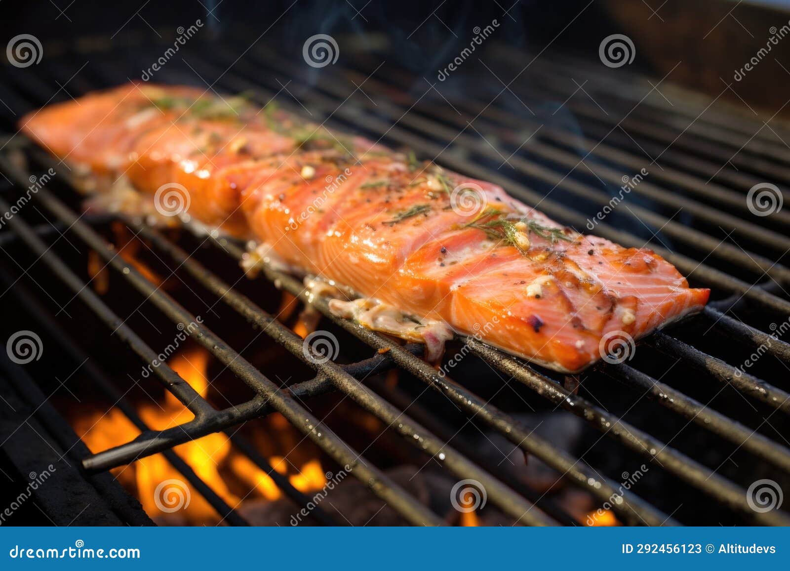 Cedar Plank Smoked Salmon Caught Midflip on a Grill Stock Image