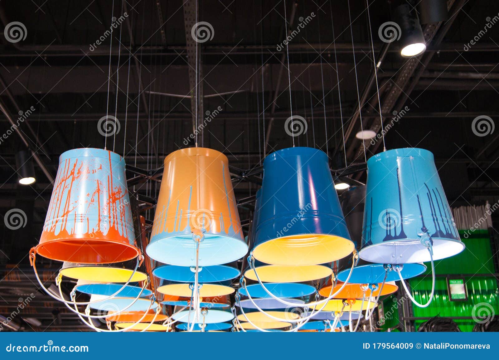 Ceiling Lights Under a Dark Ceiling Made of Colored Zinc Buckets