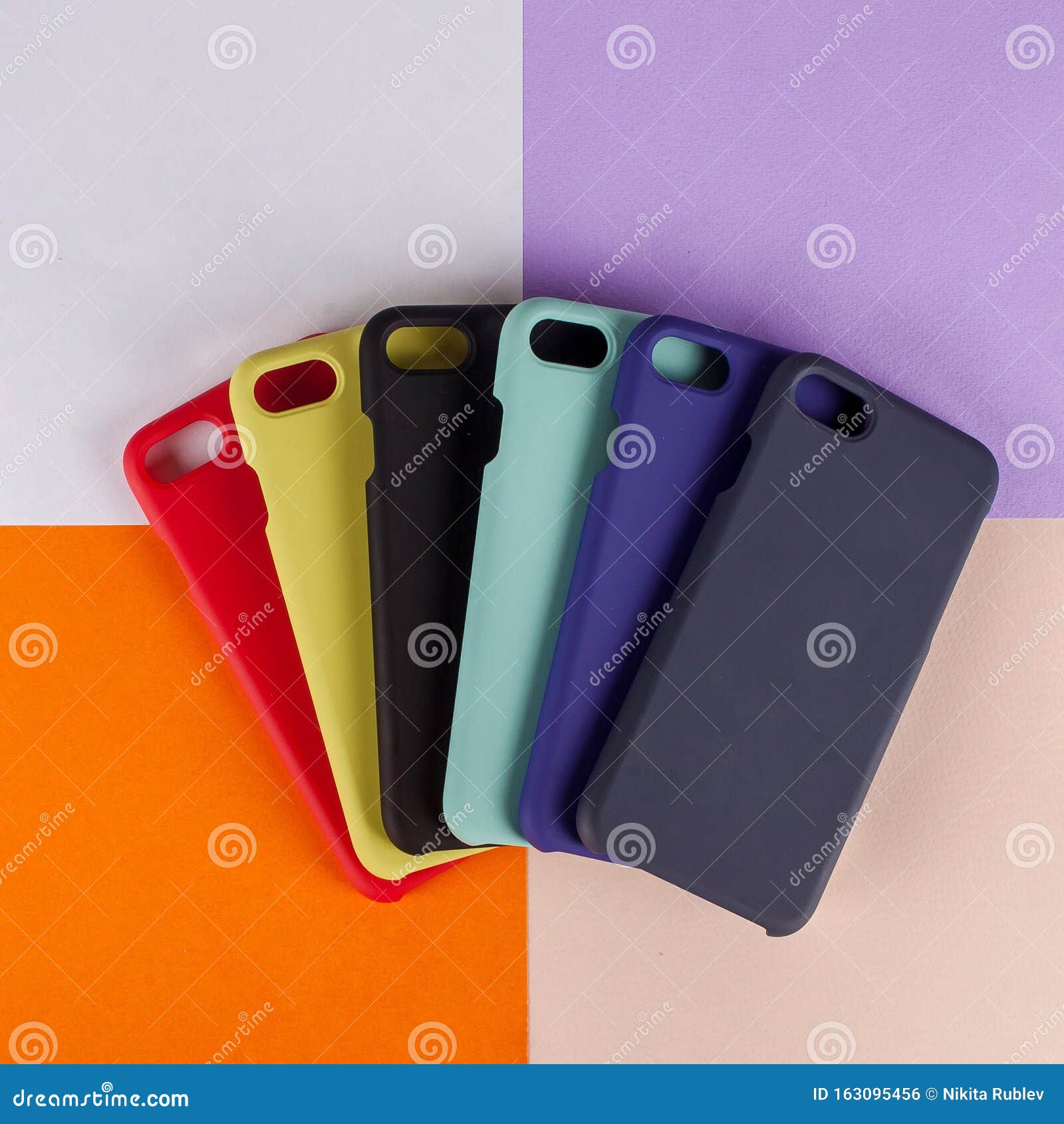 cell phone cases various colors on multicolor paper background