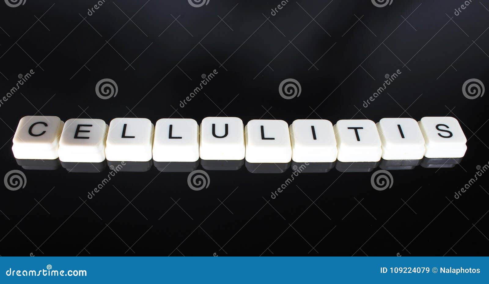cellulitis text word title caption label cover backdrop background. alphabet letter toy blocks on black reflective background. whi