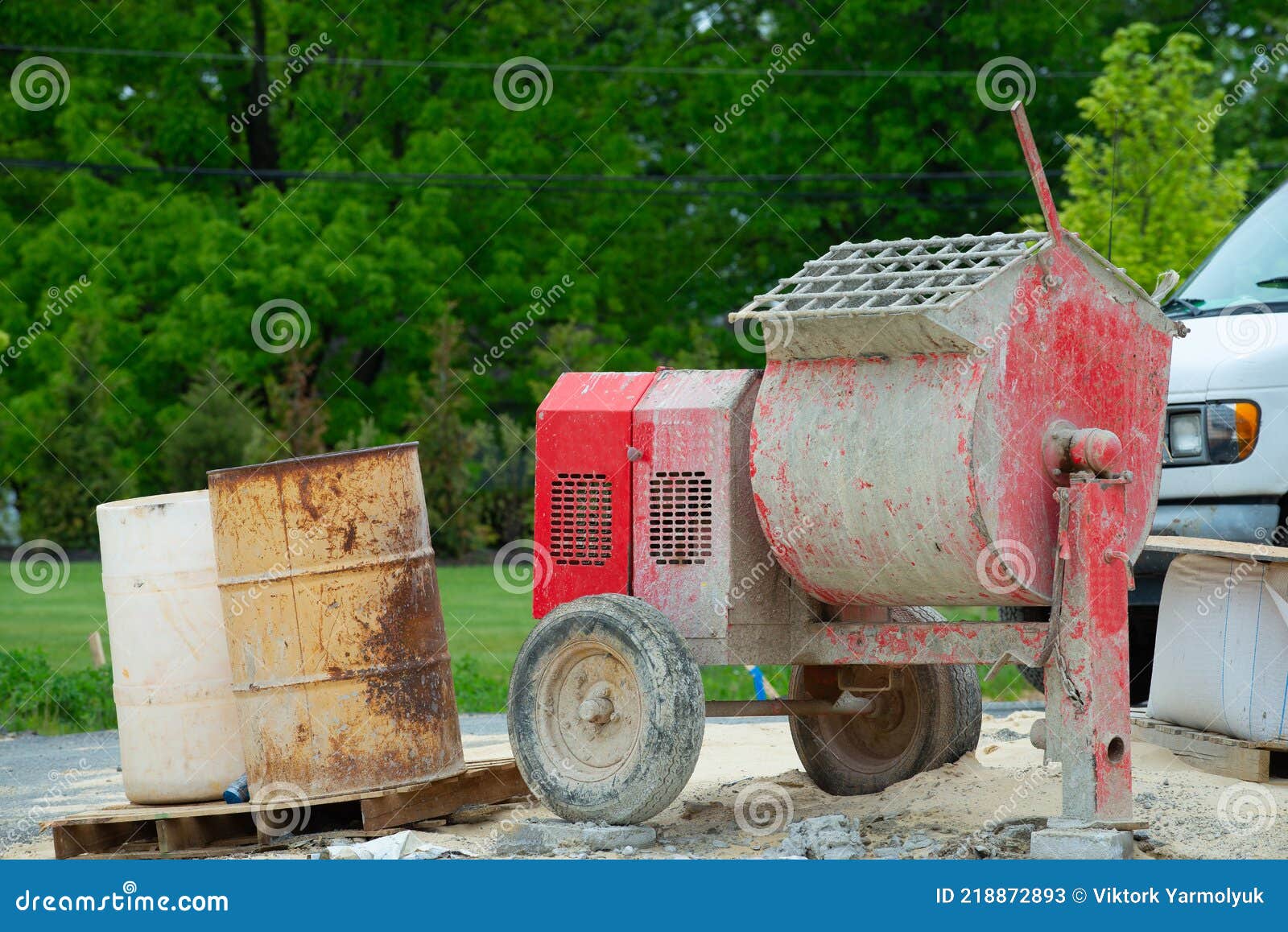 cement mixer machine at construction site, tools and sand