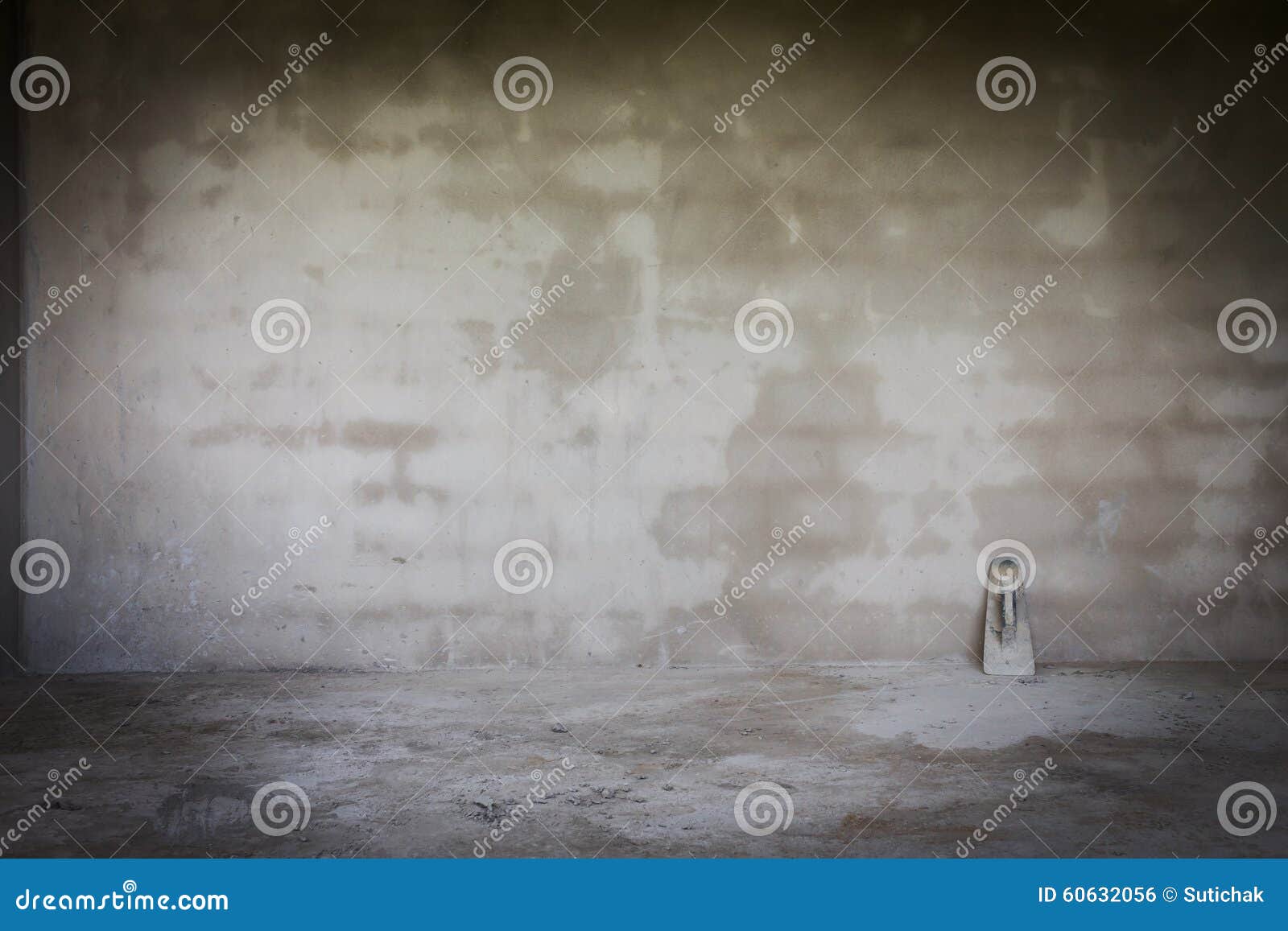 Cement Wall in Construction Site with Trowel Handheld Tool Stock Photo