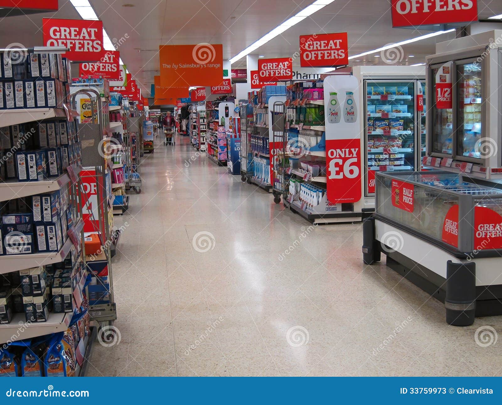 Center aisle in a food superstore. The center aisle in a large supermarket with all the various aisles going off in either direction. many signs for great offers displayed. This is in the Sainsbury supermarket at Bedford, England, United Kingdom.