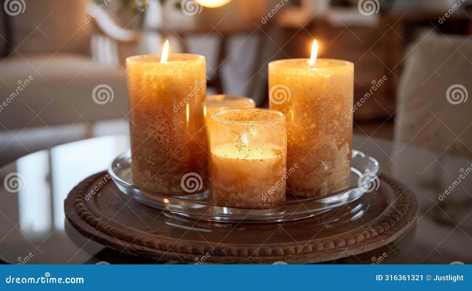 in the center of a round glass dining table a group of rustic mismatched candles casts a warm glow over the room. 2d