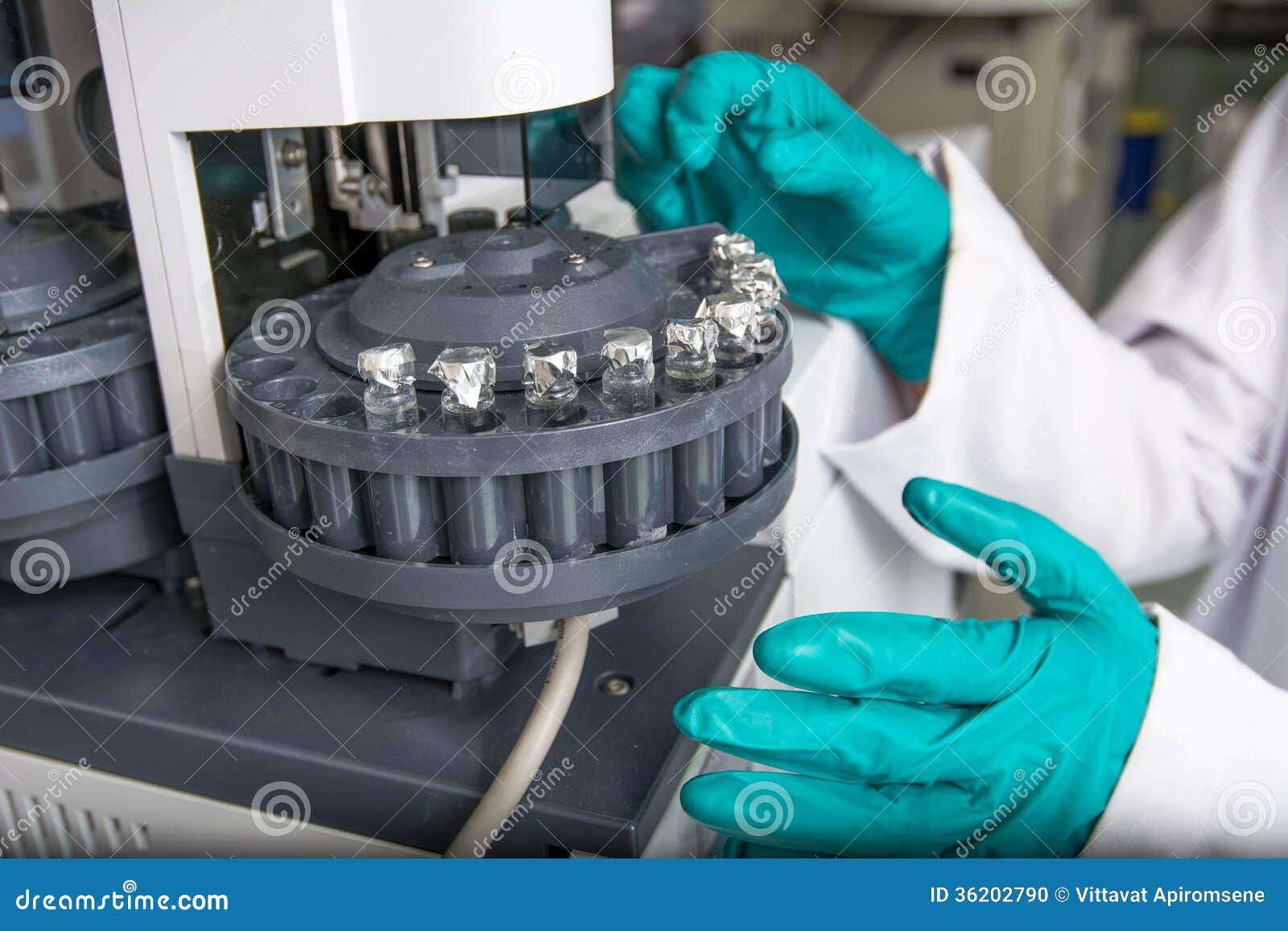 Centrifuge with Experiment Tubes and Hands in Gloves Stock Photo