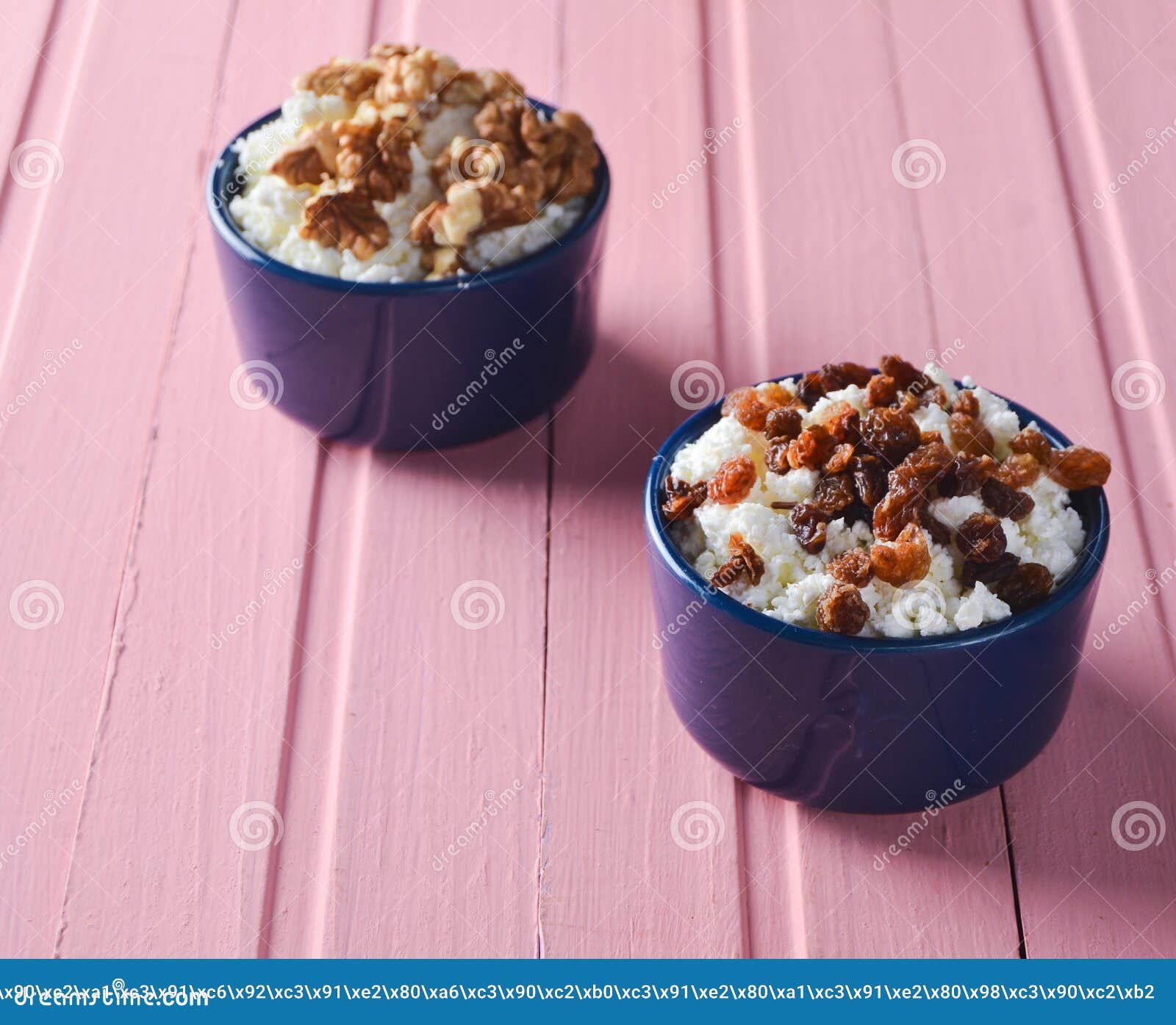 Ceramic Bowls Of Cottage Cheese With Raisins And Walnuts On A Pink