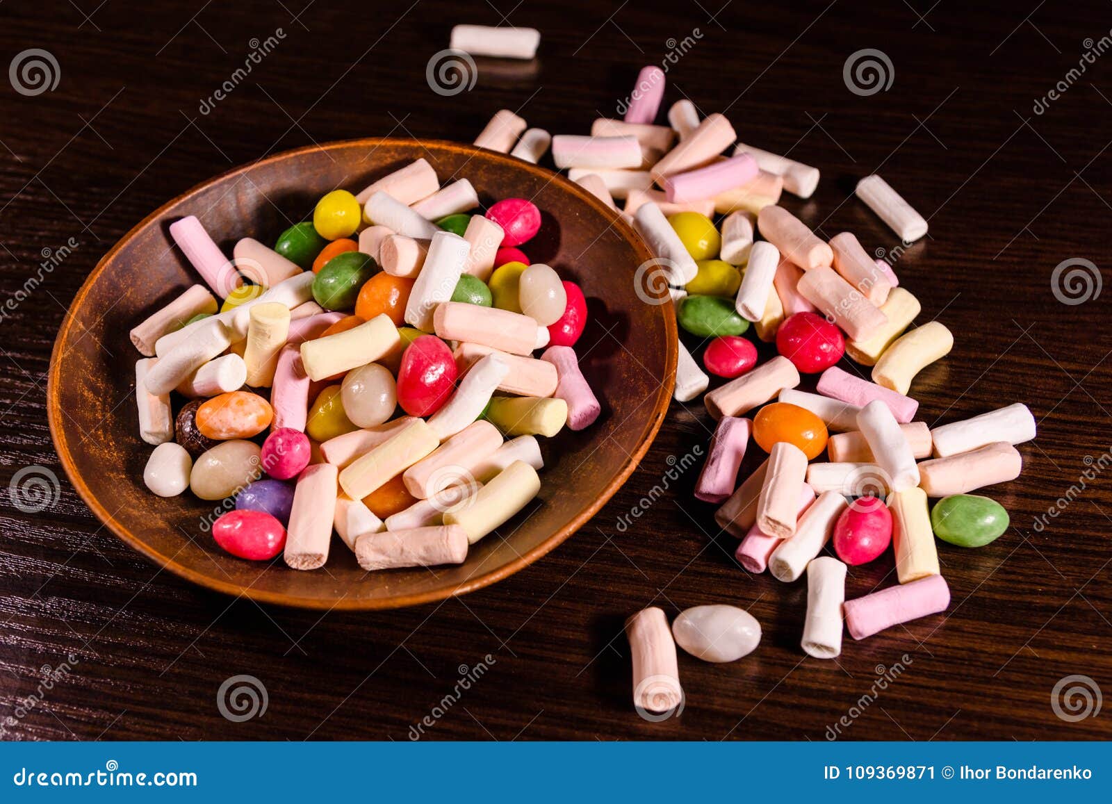 Ceramic Dish with the Different Multi Colored Candies on a Dark Stock