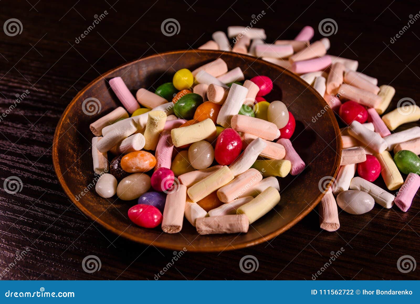 Ceramic Dish with the Different Multi Colored Candies on a Dark Stock