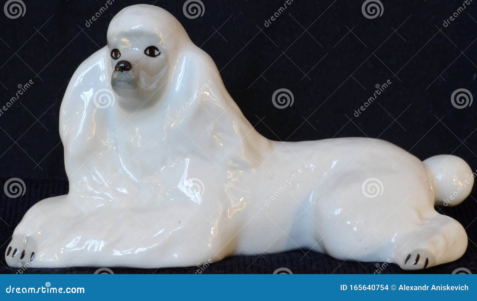 Statuette, Sculpture of a White Reclining Dog Stock Photo Image of