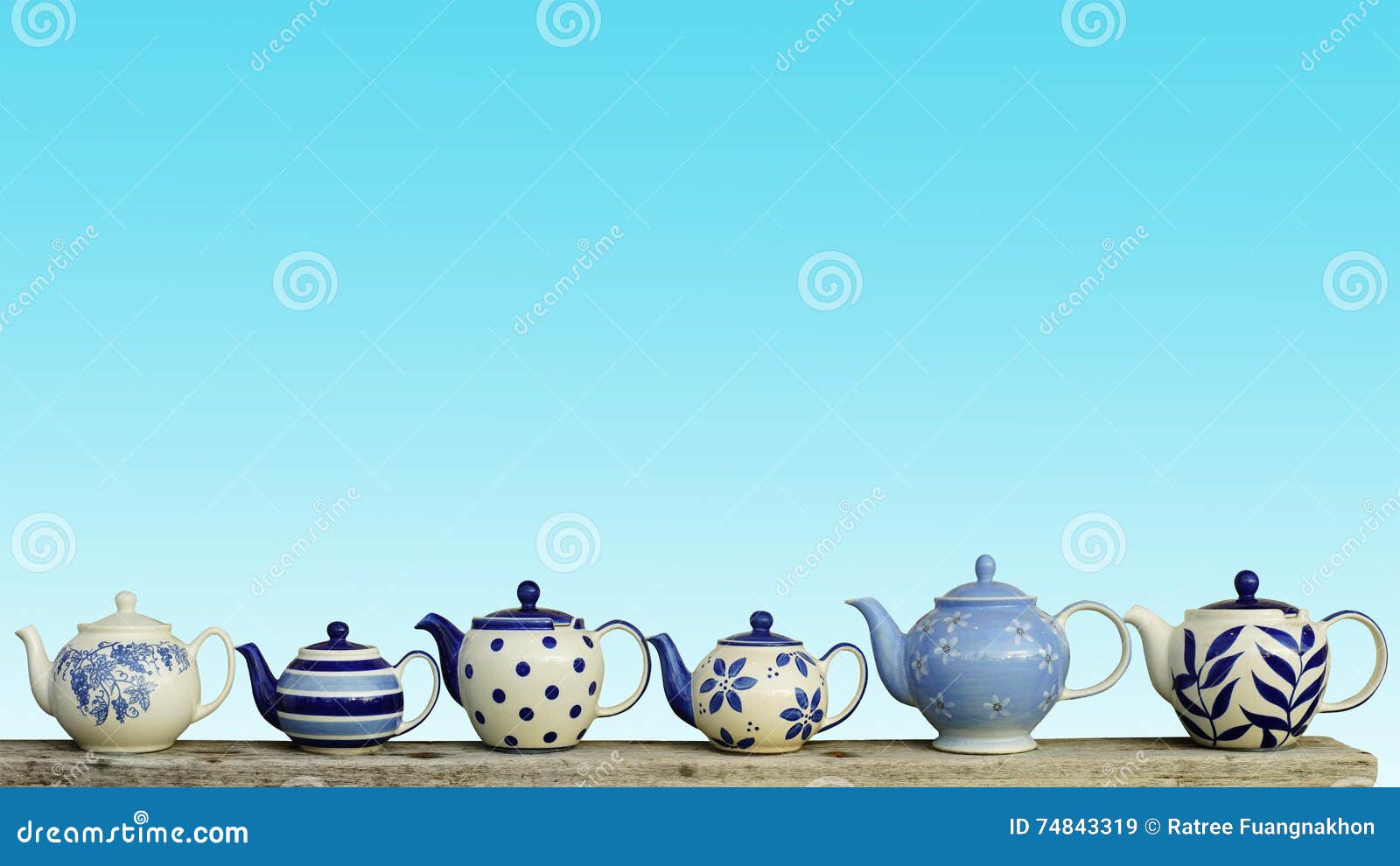 ceramic teapot with blue pastel wall background.