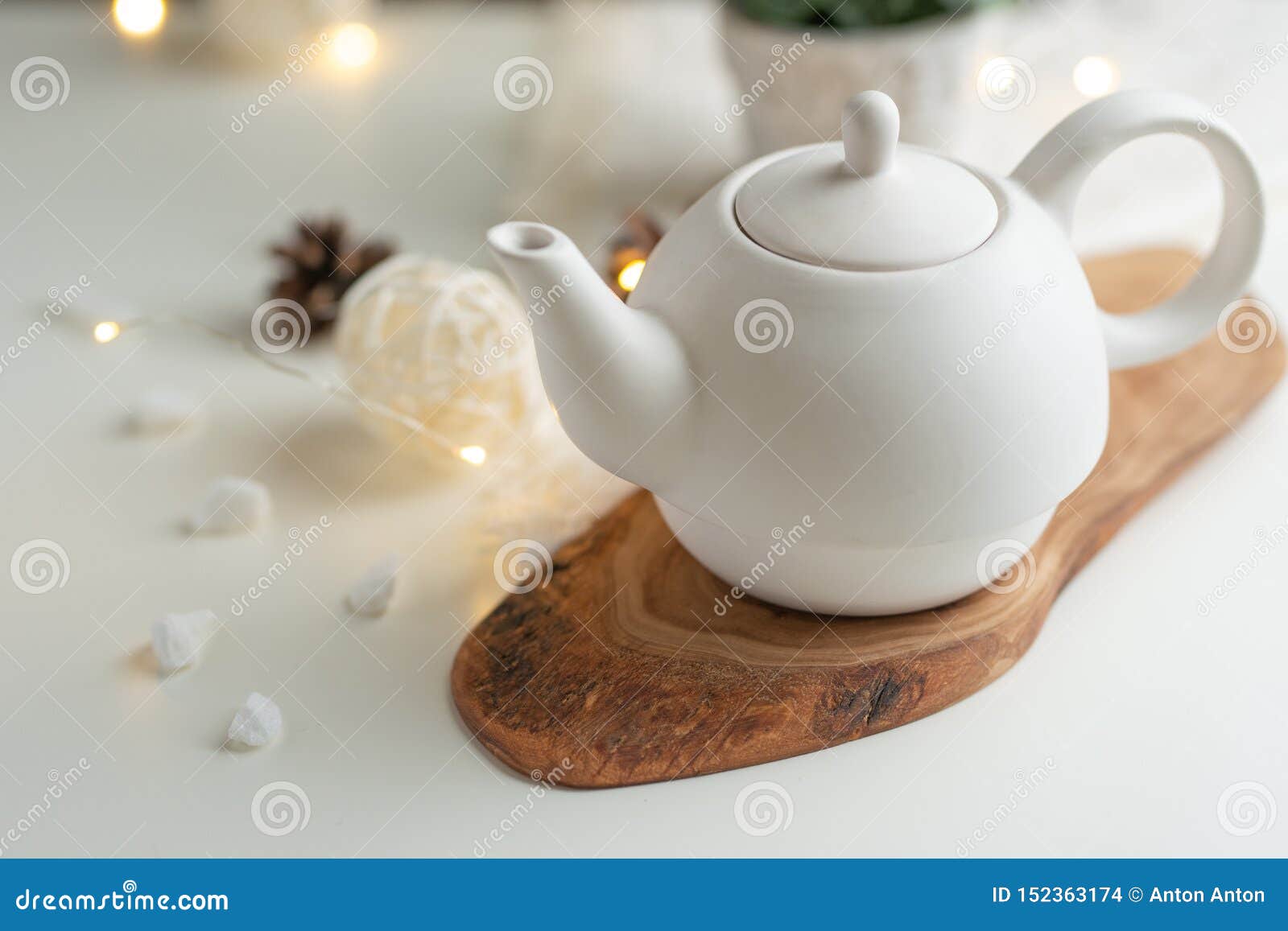 Ceramic White Teapot with Accessories on a White Table, Horizontal