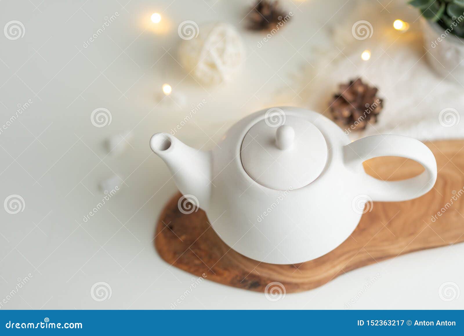 Ceramic White Teapot with Accessories on a White Table, Horizontal