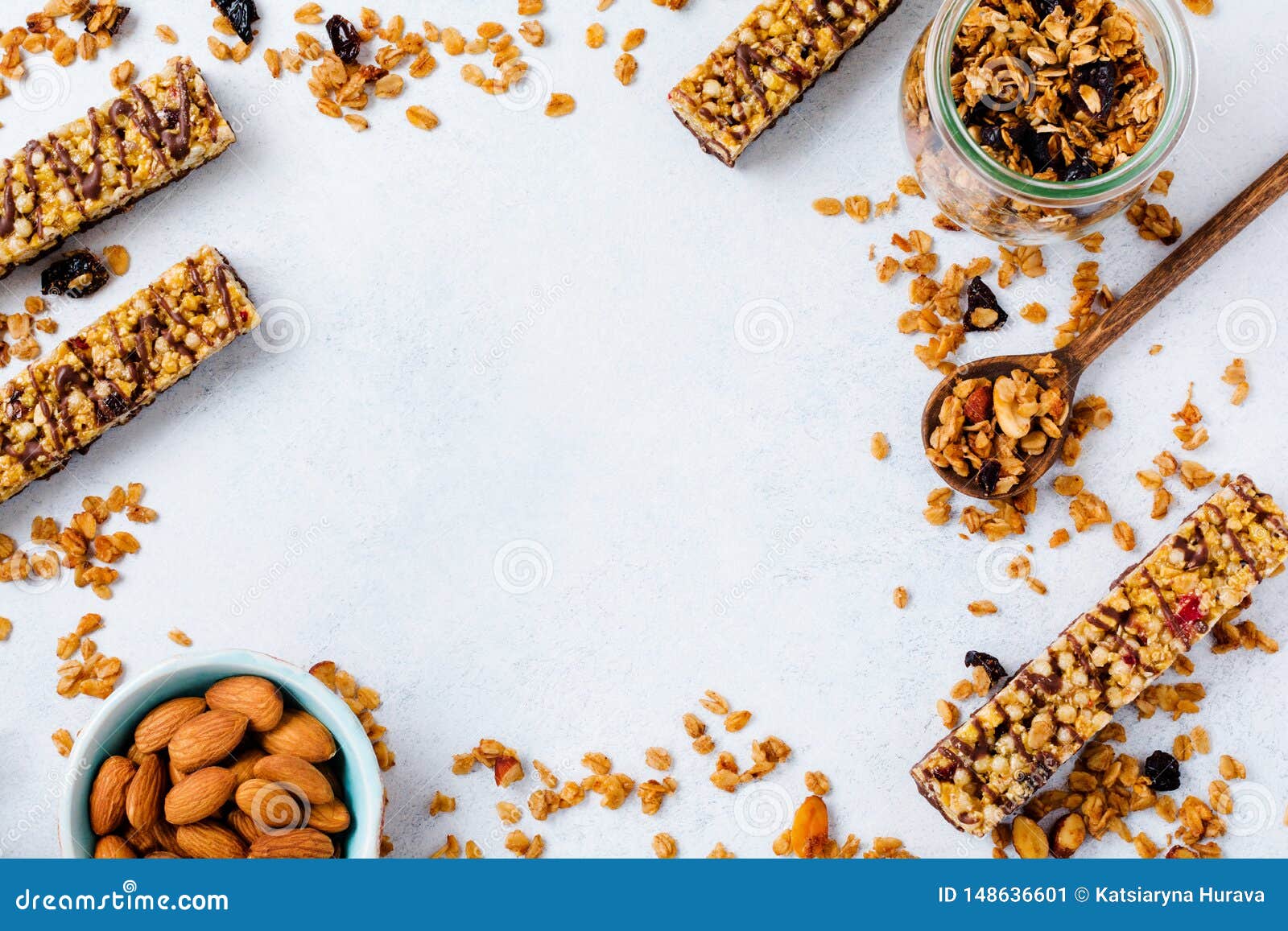 cereal granola bar with nuts, fruits and berries on a whhite stone table. granola bar. healthy snack.