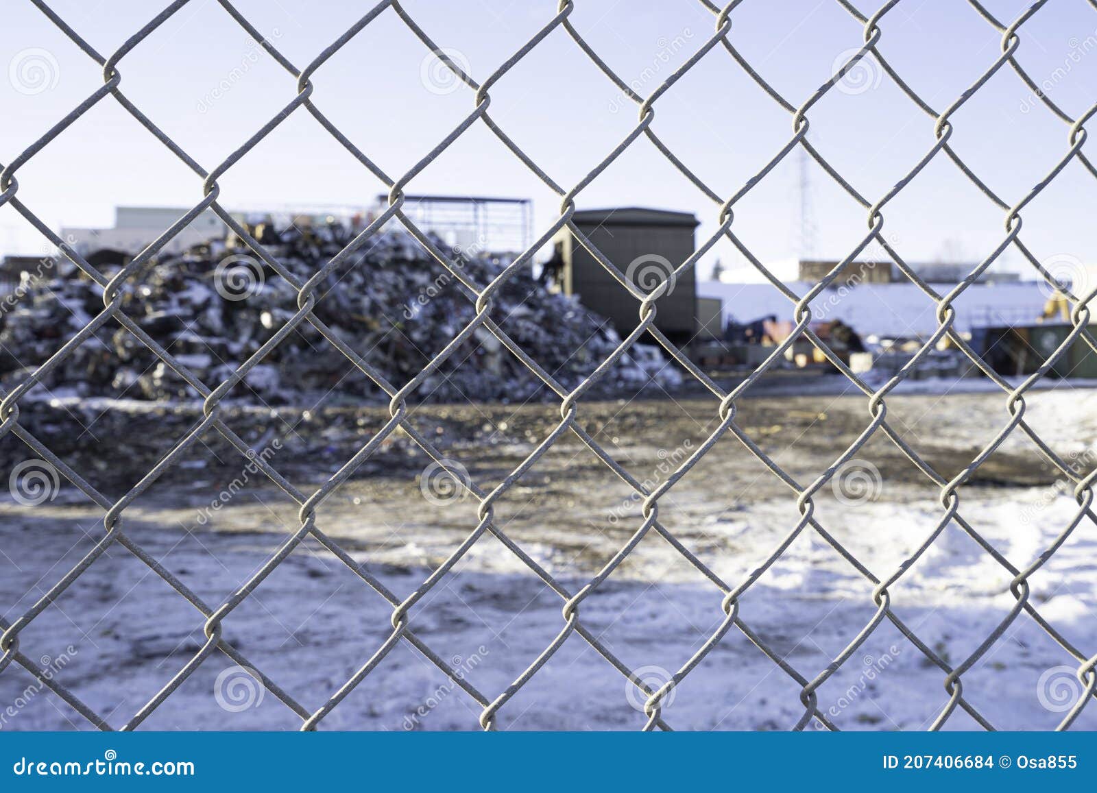 Chain Link Fence with Garbage Recycle Dump Behind it Stock Photo