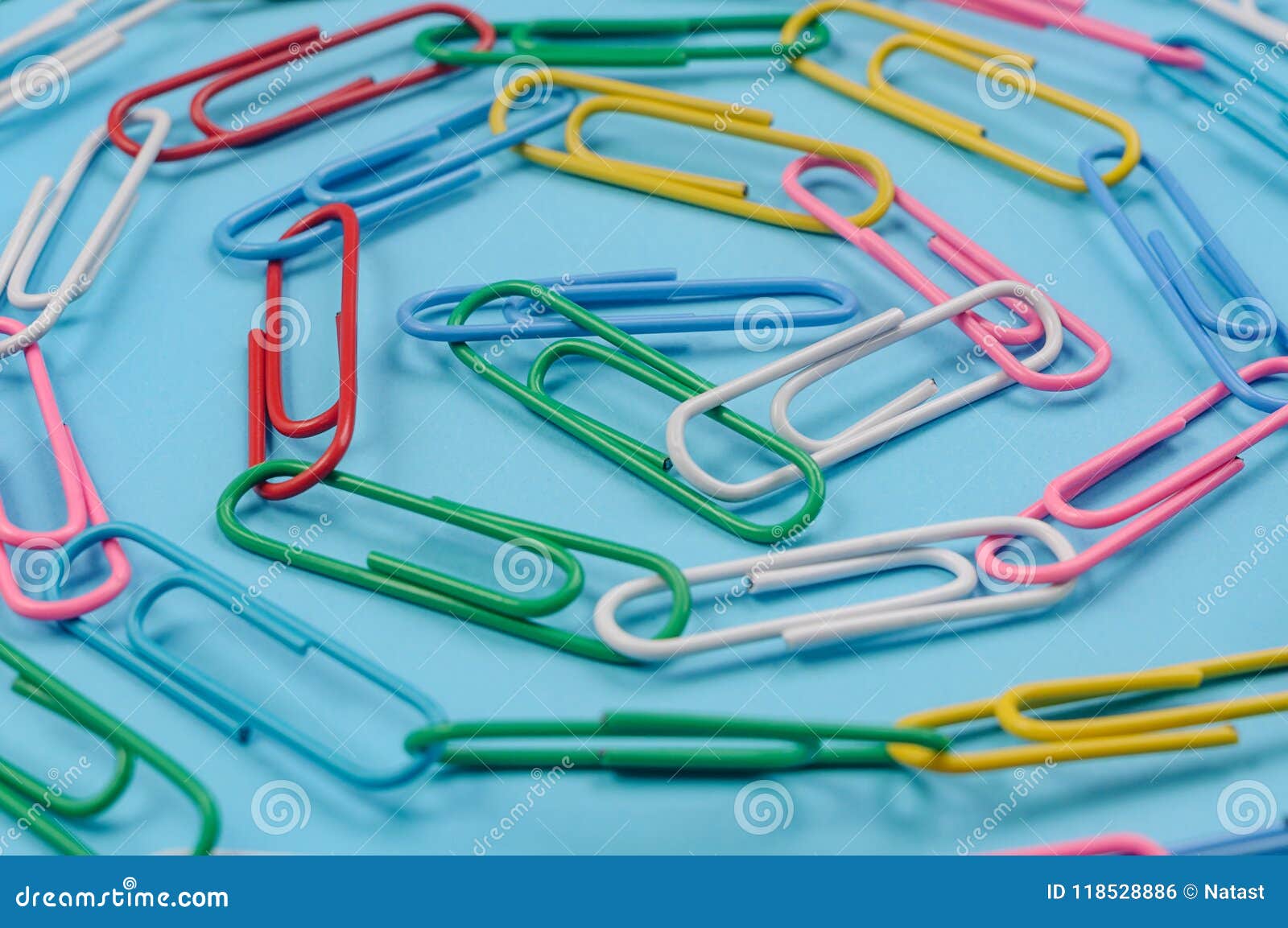 chain made of paper clips on blue
