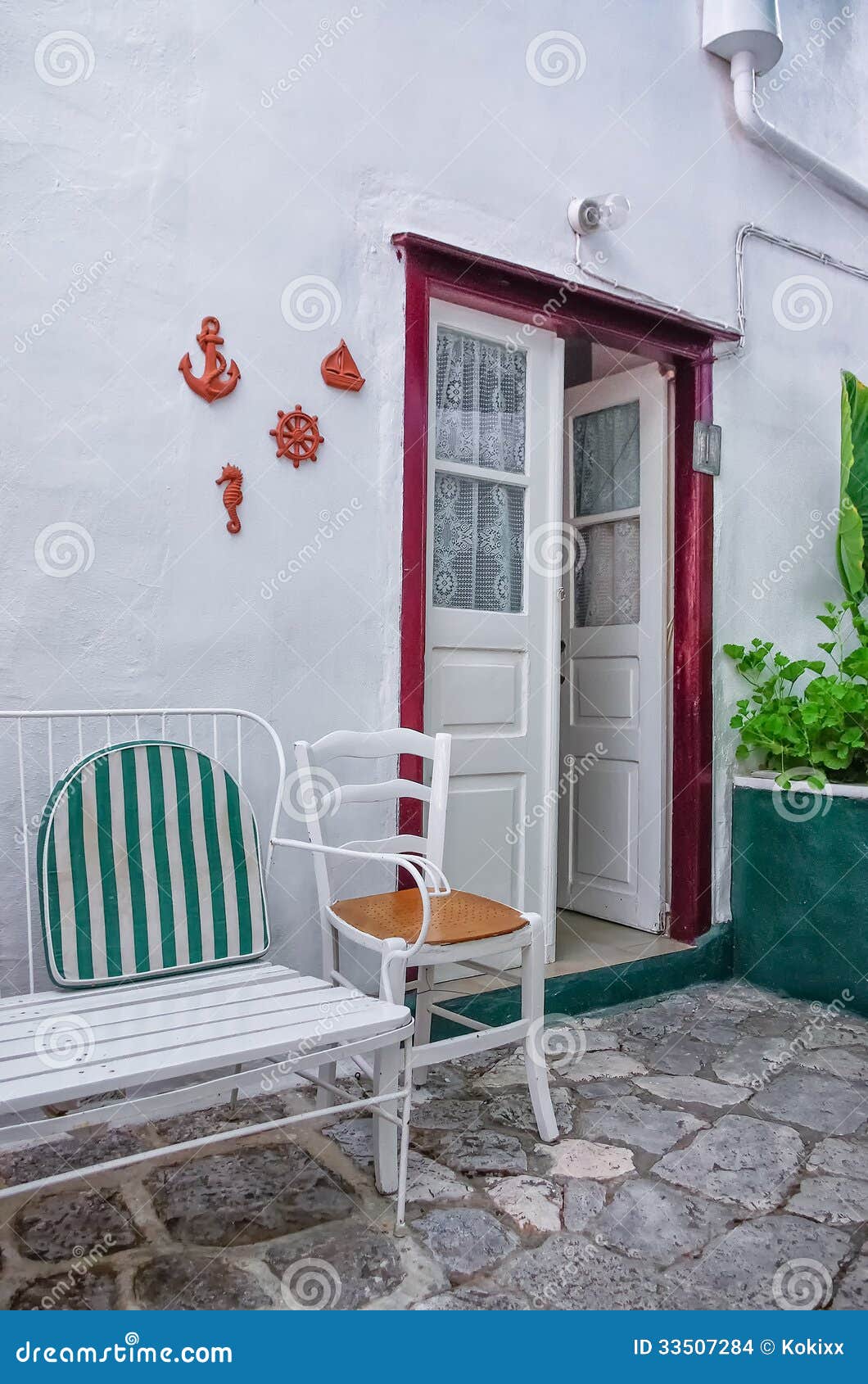 Chair in the alley. Yard of an old Greek house, in Hydra island