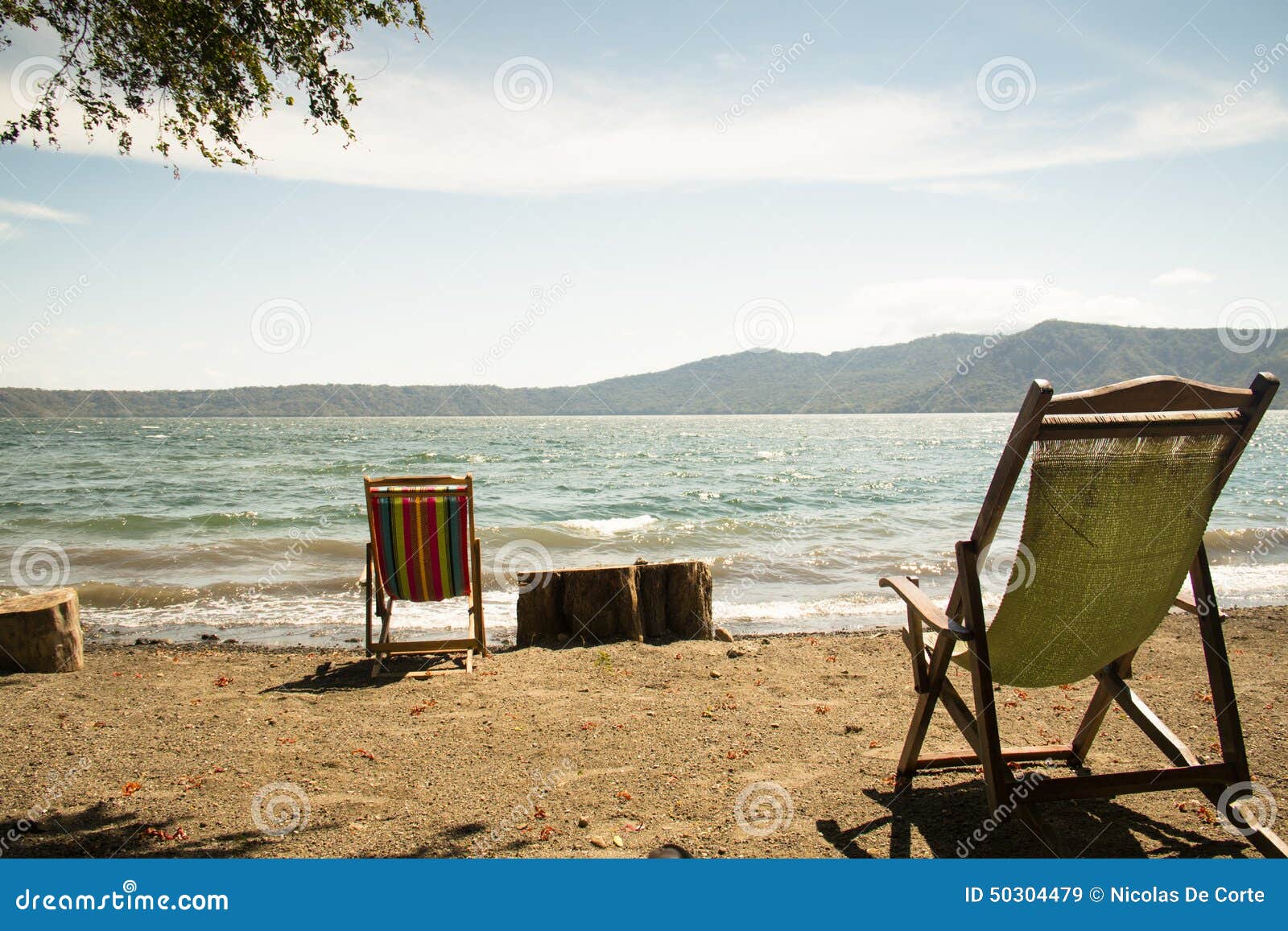 chairs at the shore of lake apoyo near granada, nicaragua