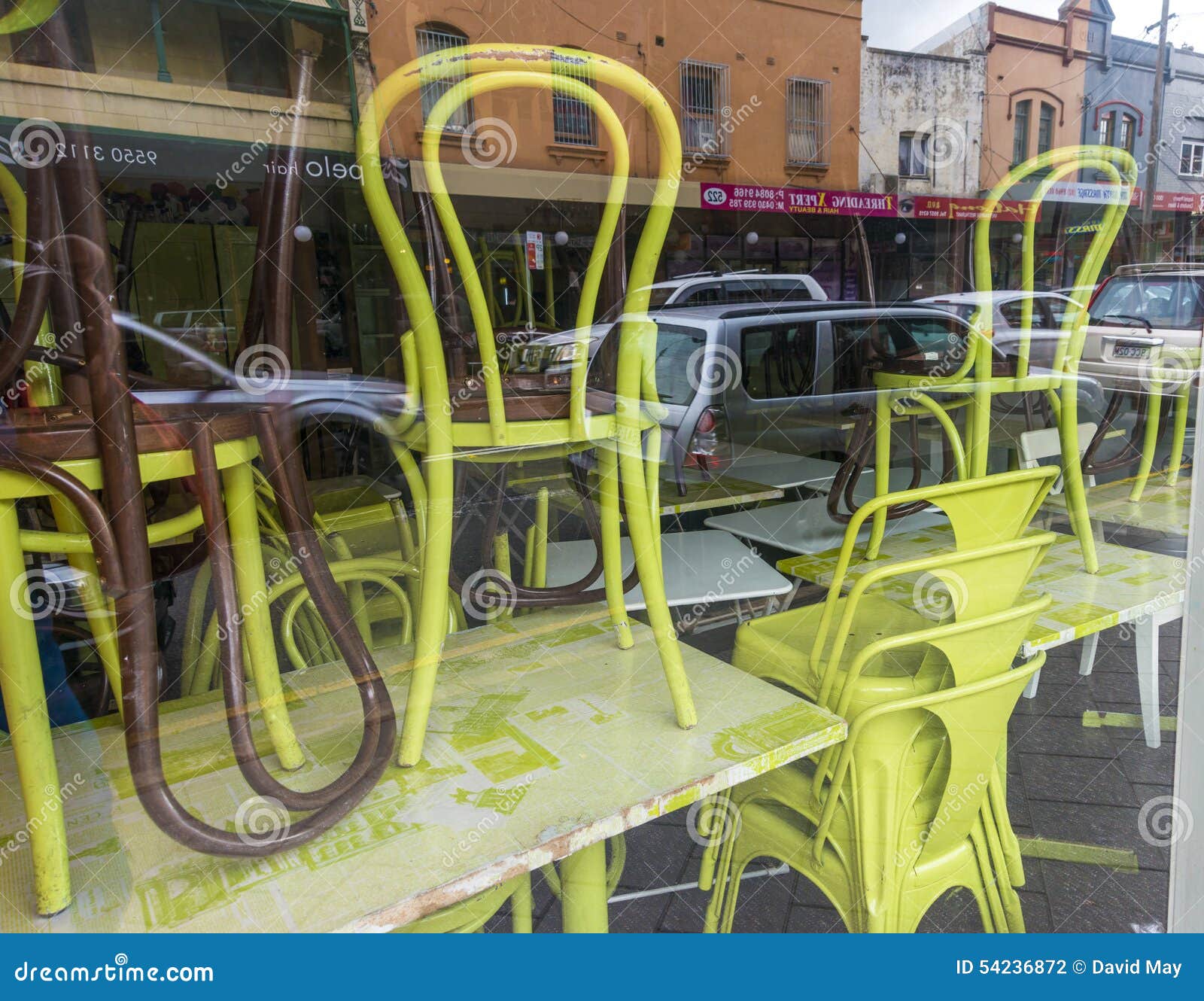 Chairs Stacked Up in a Restaurant Window Editorial Photography Image