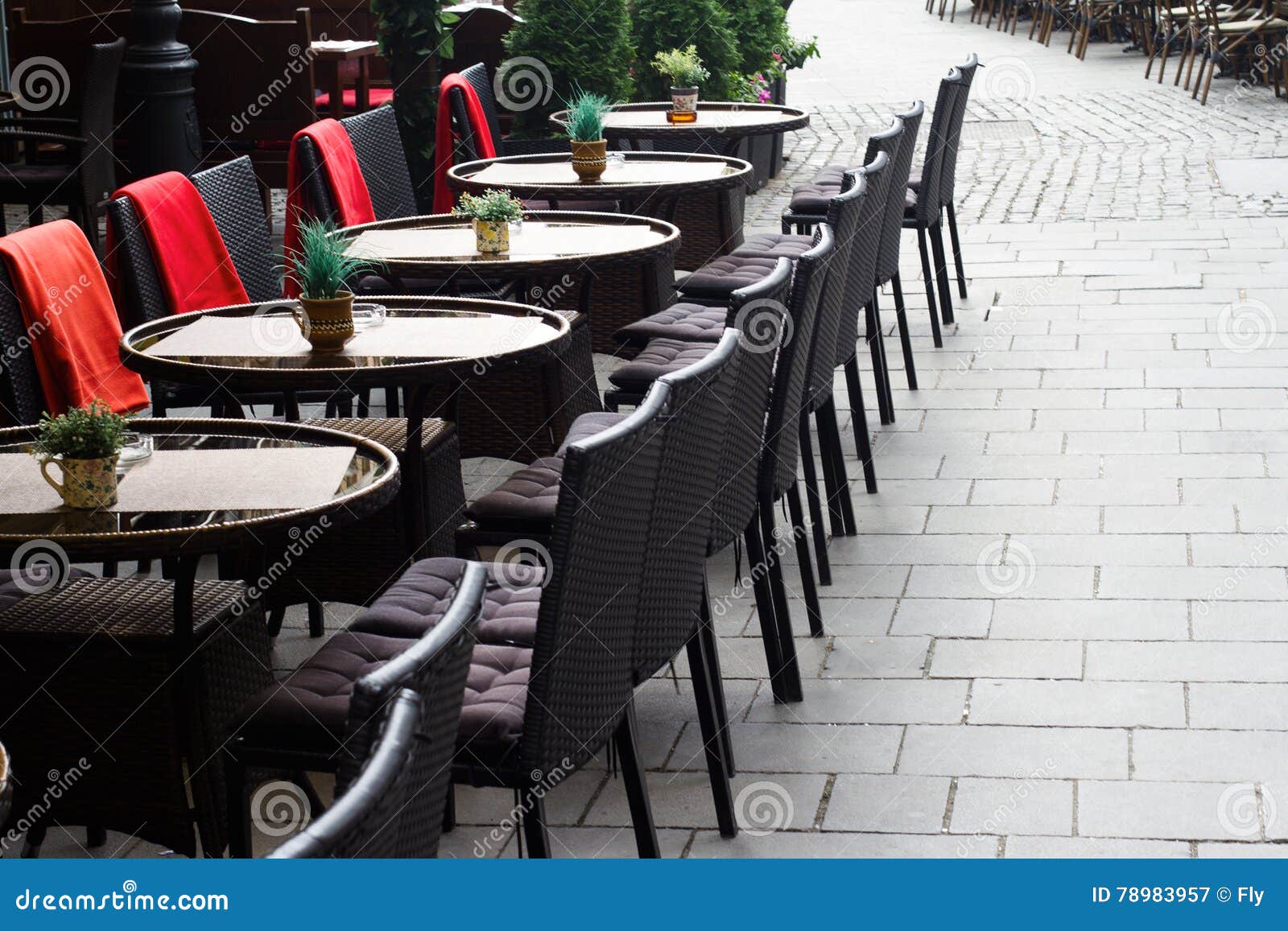 Chairs and Tables on the Terrace of a Restaurant in the Afternoon Stock