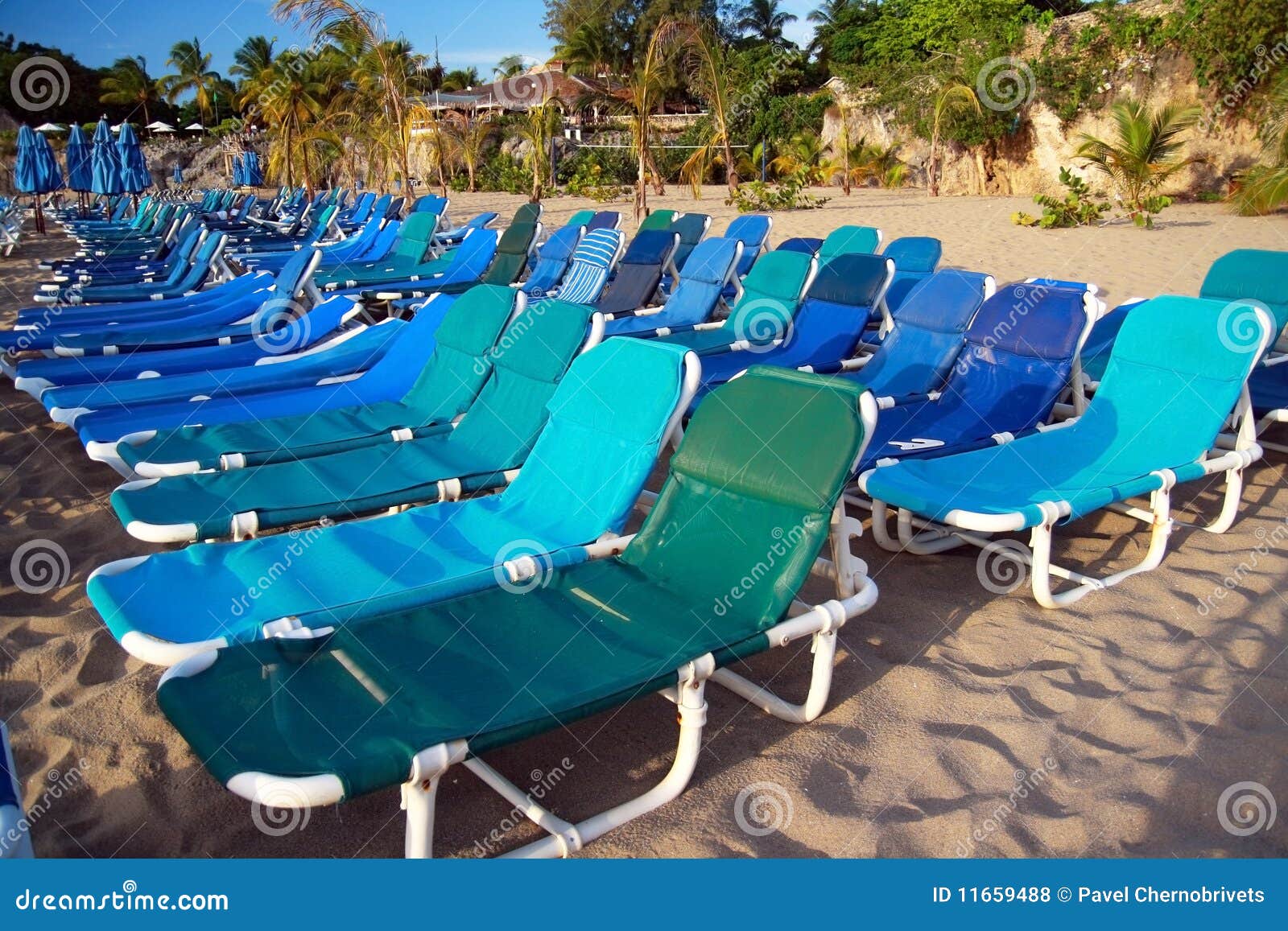 Chaiselongues on beach stock photo. Image of longue 11659488