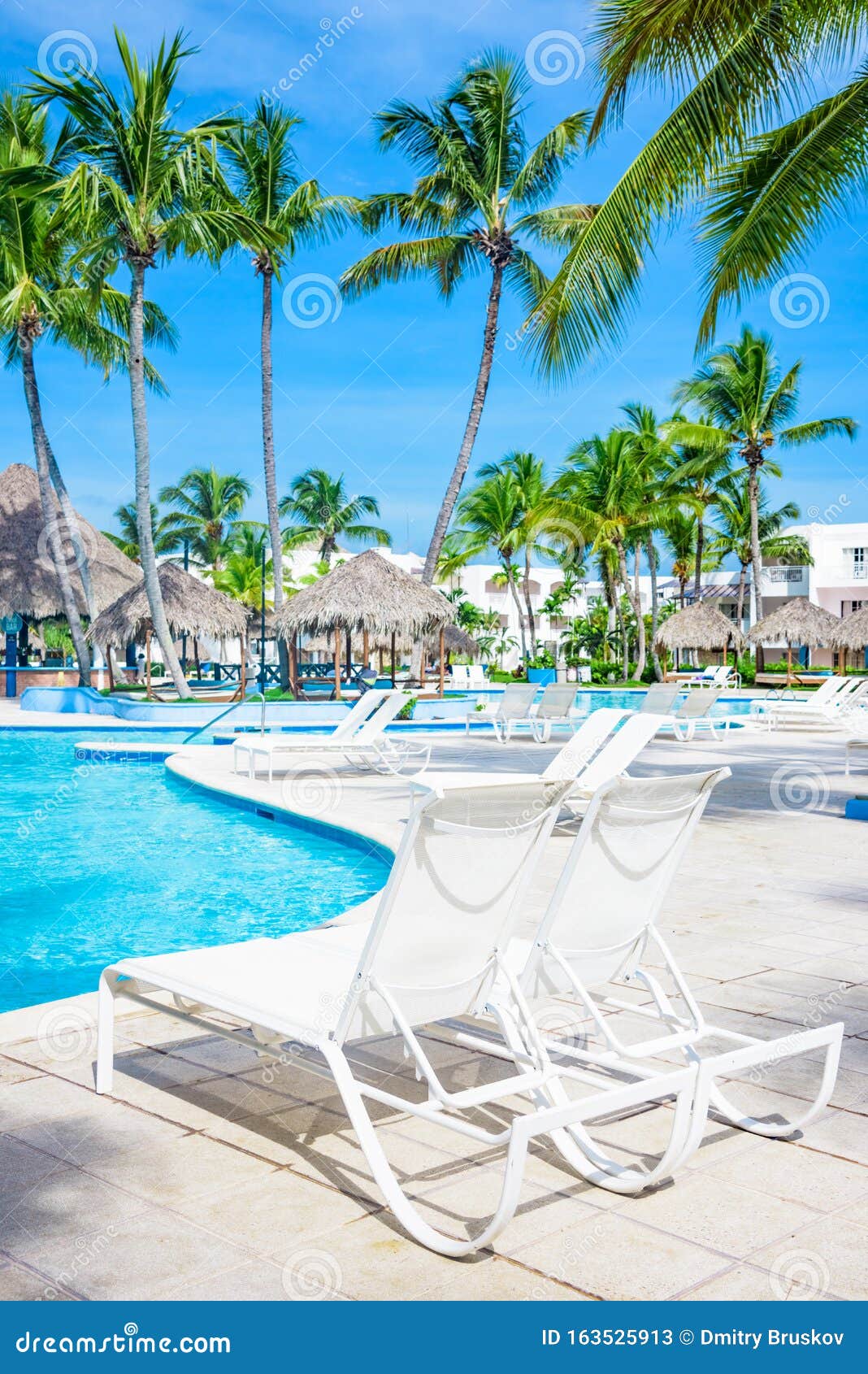 Chaise lounge by the pool stock image. Image of hotel 163525913