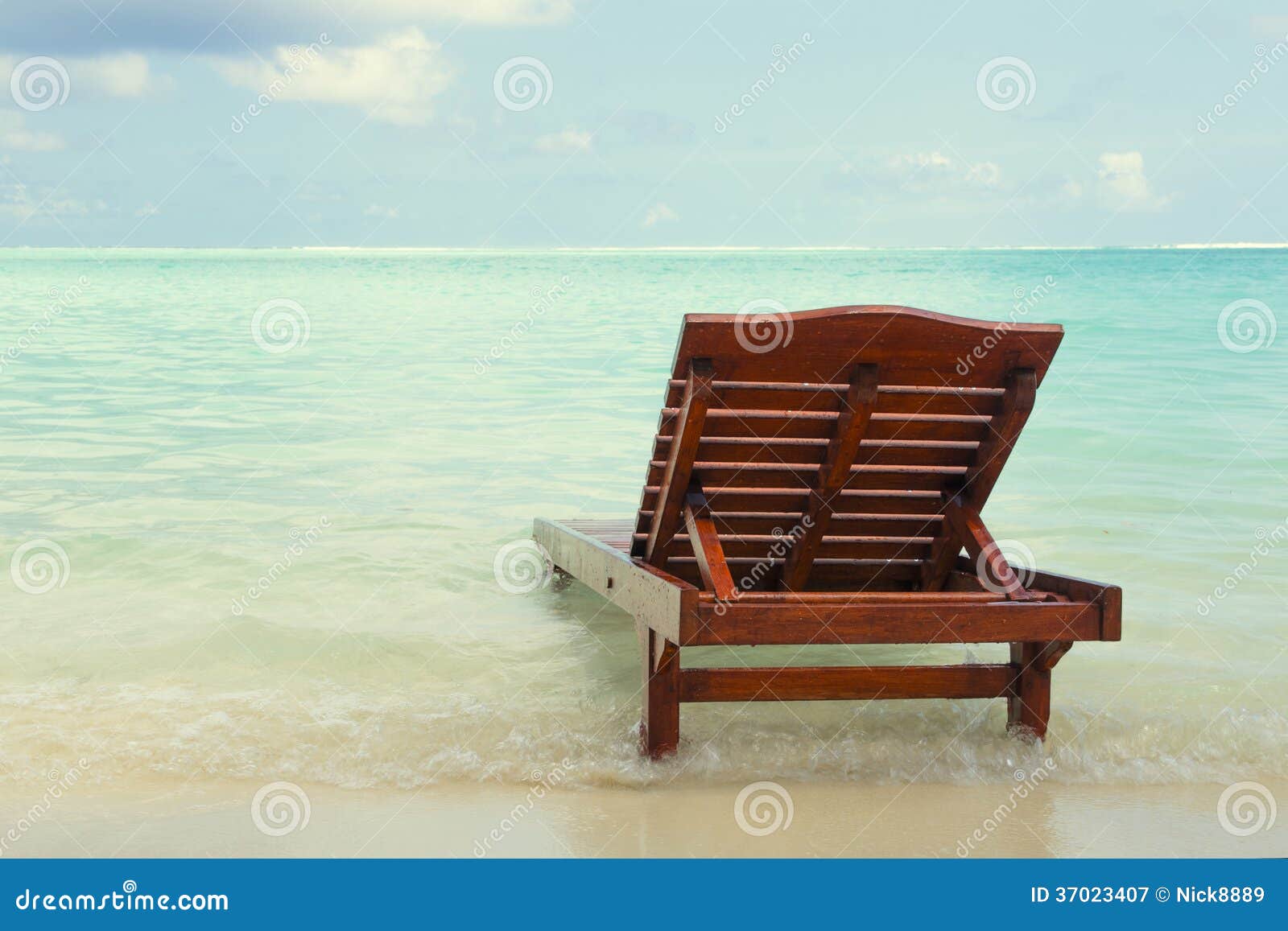 Chaise lounge in the water stock image. Image of coastline 37023407