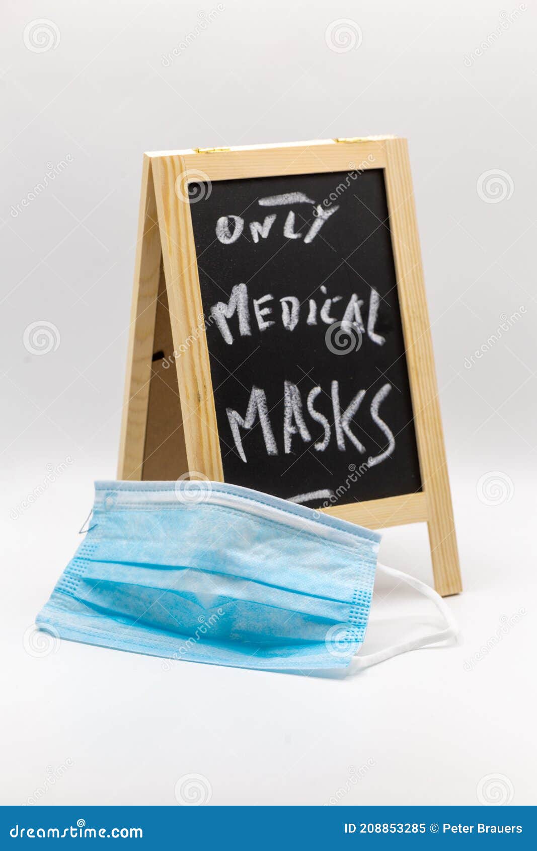 chalkboard with note only medicals masks as warning with medical mask in the foreground at covid-19 times