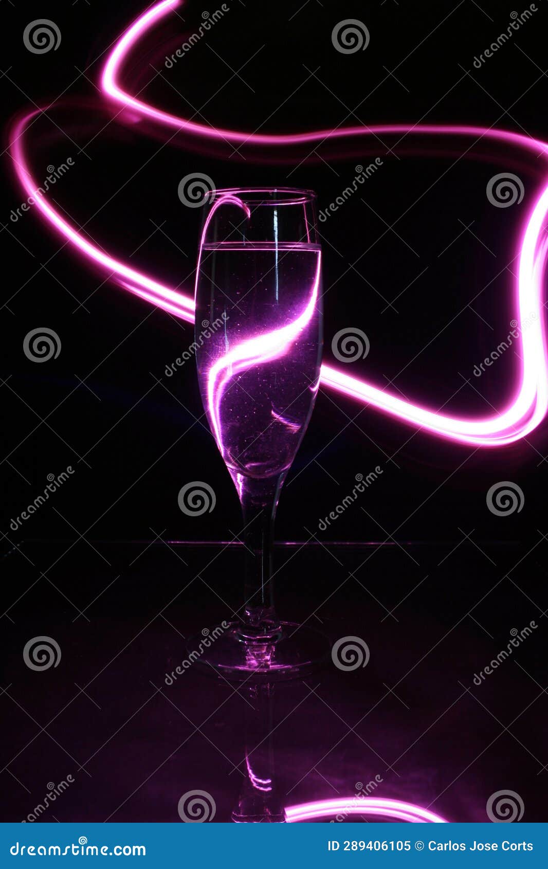 the champagne or champagne glass surrounded by pink lines of light