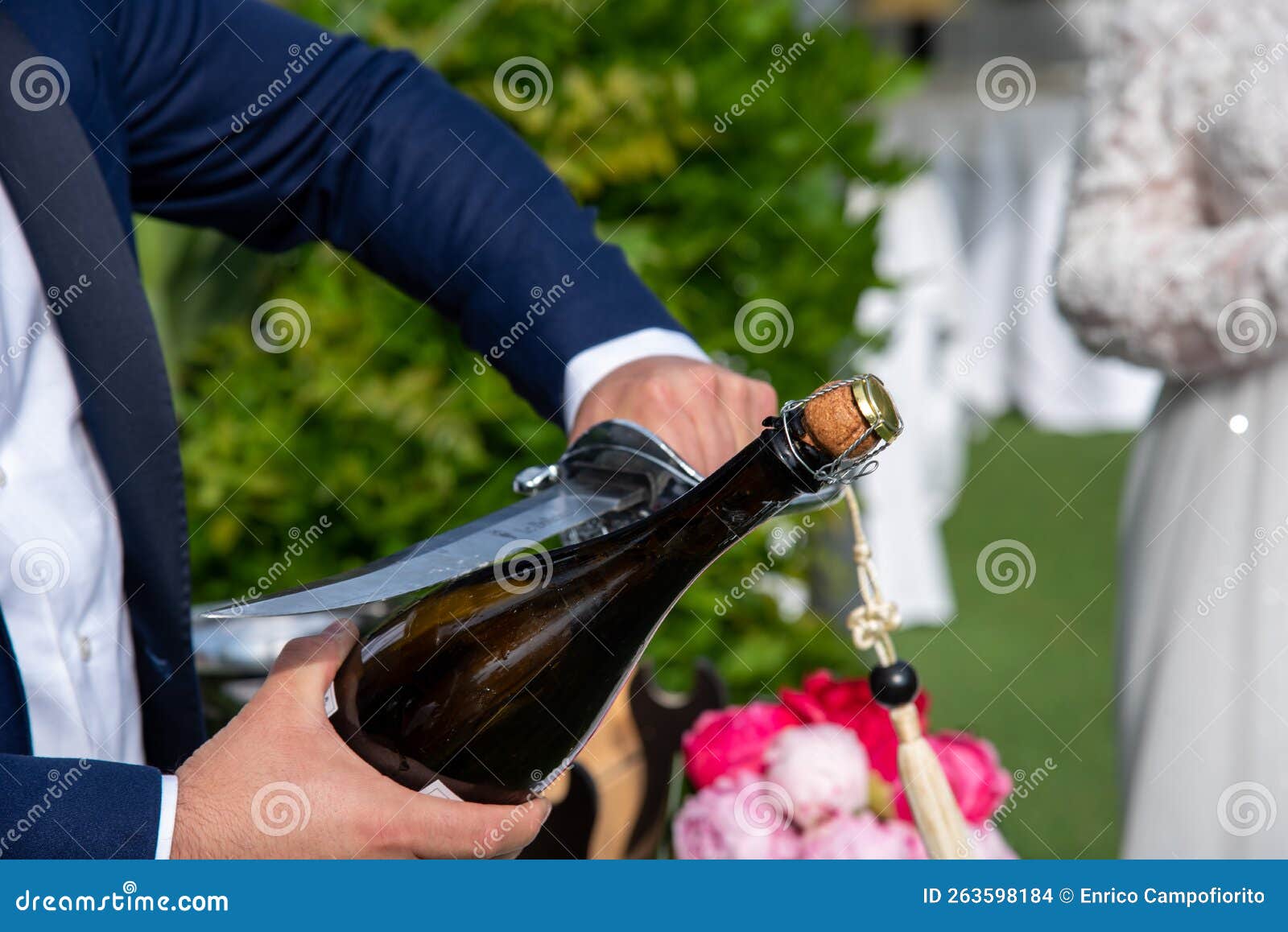 champagne saber close-up while open a bottle in a wedding