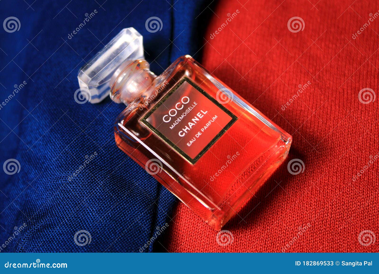 Chanel Perfume Bottle Isolated on Red & Blue Background. Bottle with ...