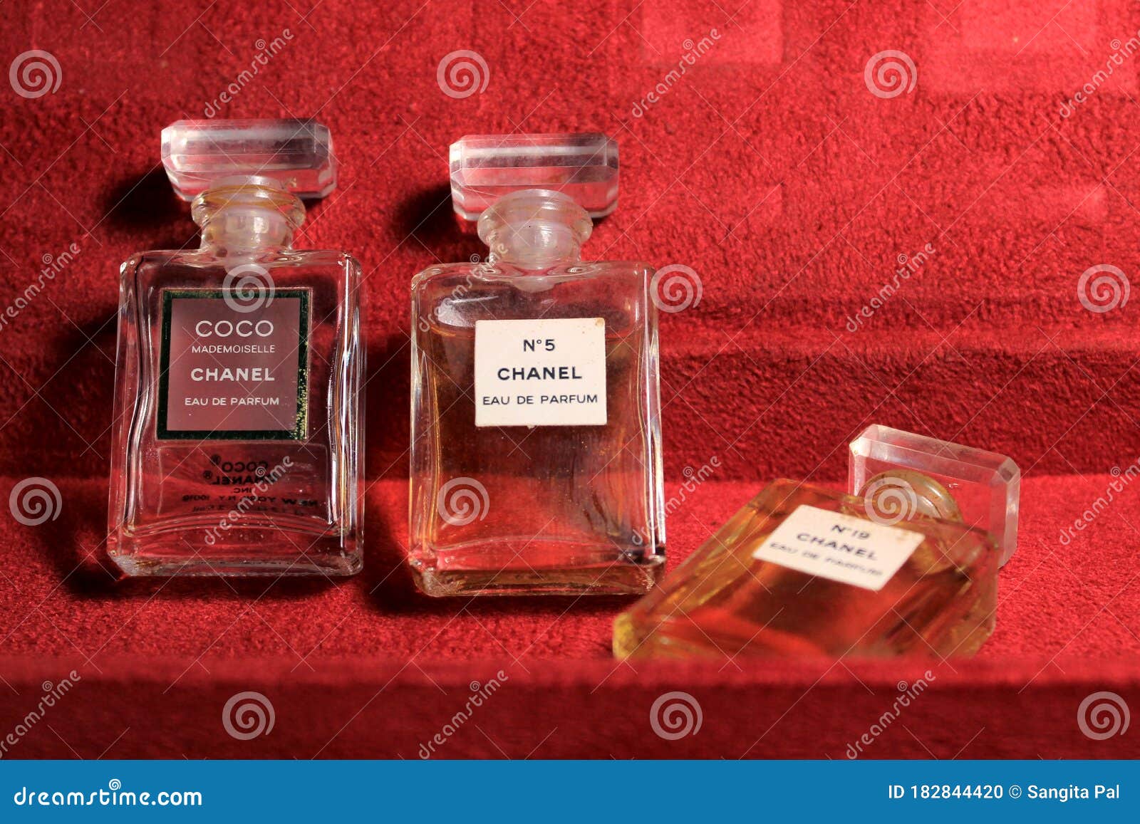 Chanel Perfume Bottles Isolated on Red Background. Bottles with