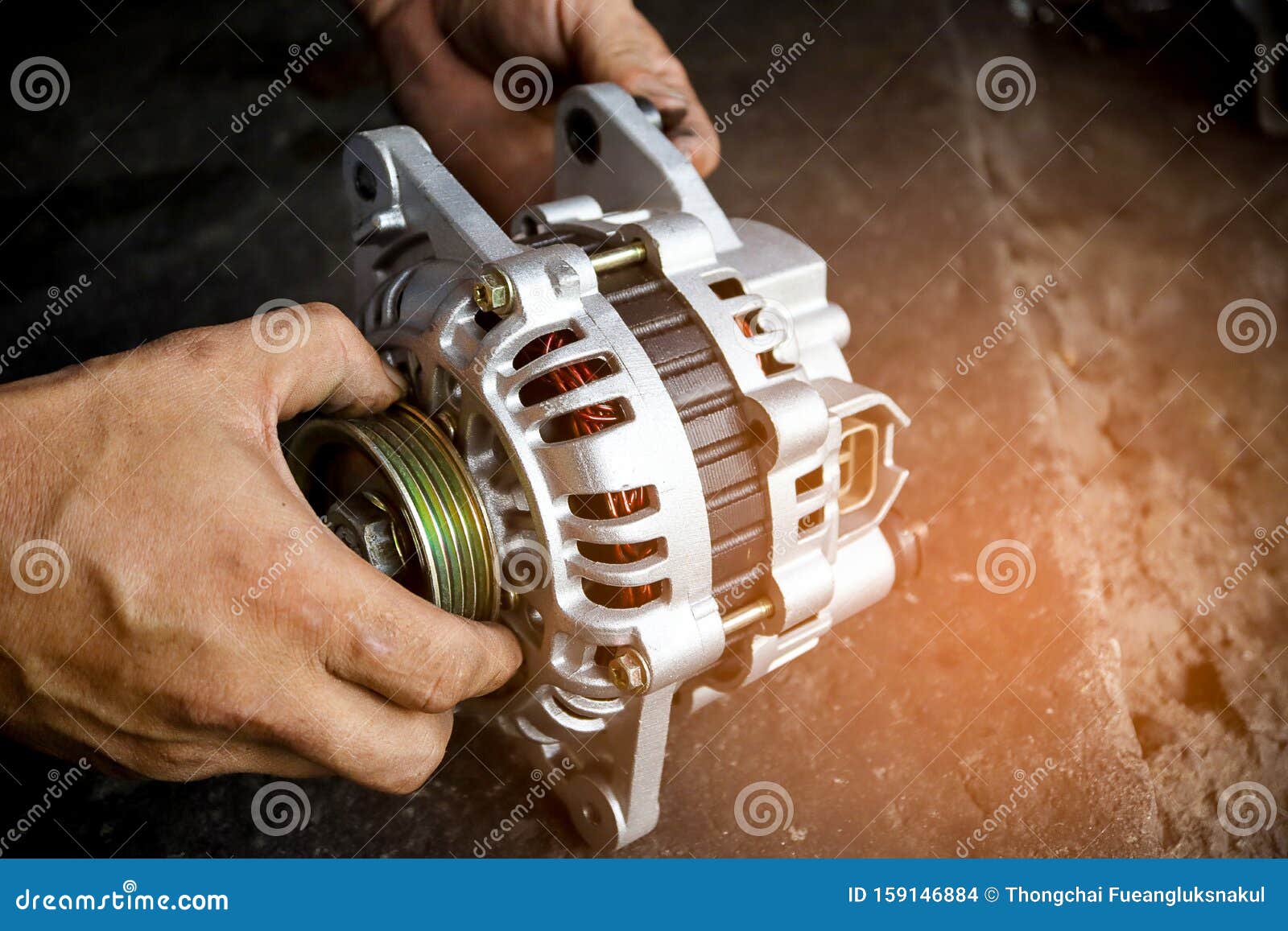 change new car alternator with hand in the garage or auto repair service center, as background automotive concept. dark tone