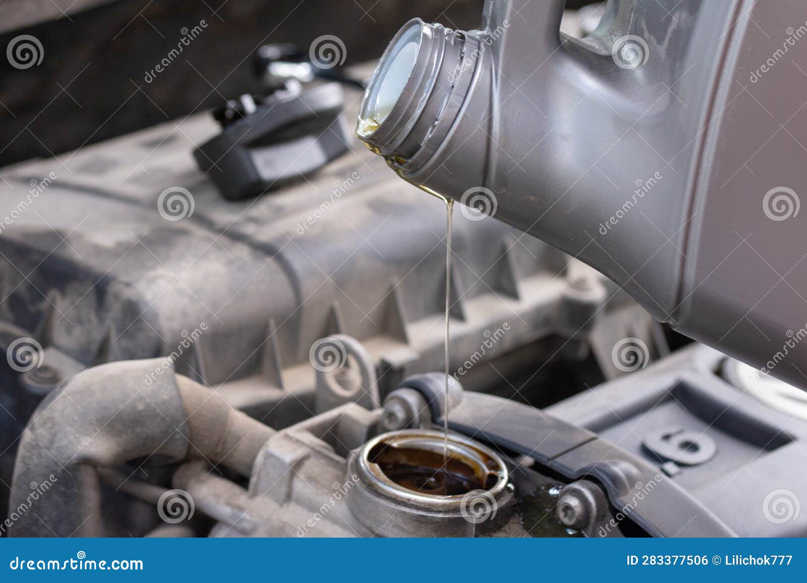 Changing Engine Oil in a Car, Oil from a Bottle is Poured into the Engine Stock Photo Image of