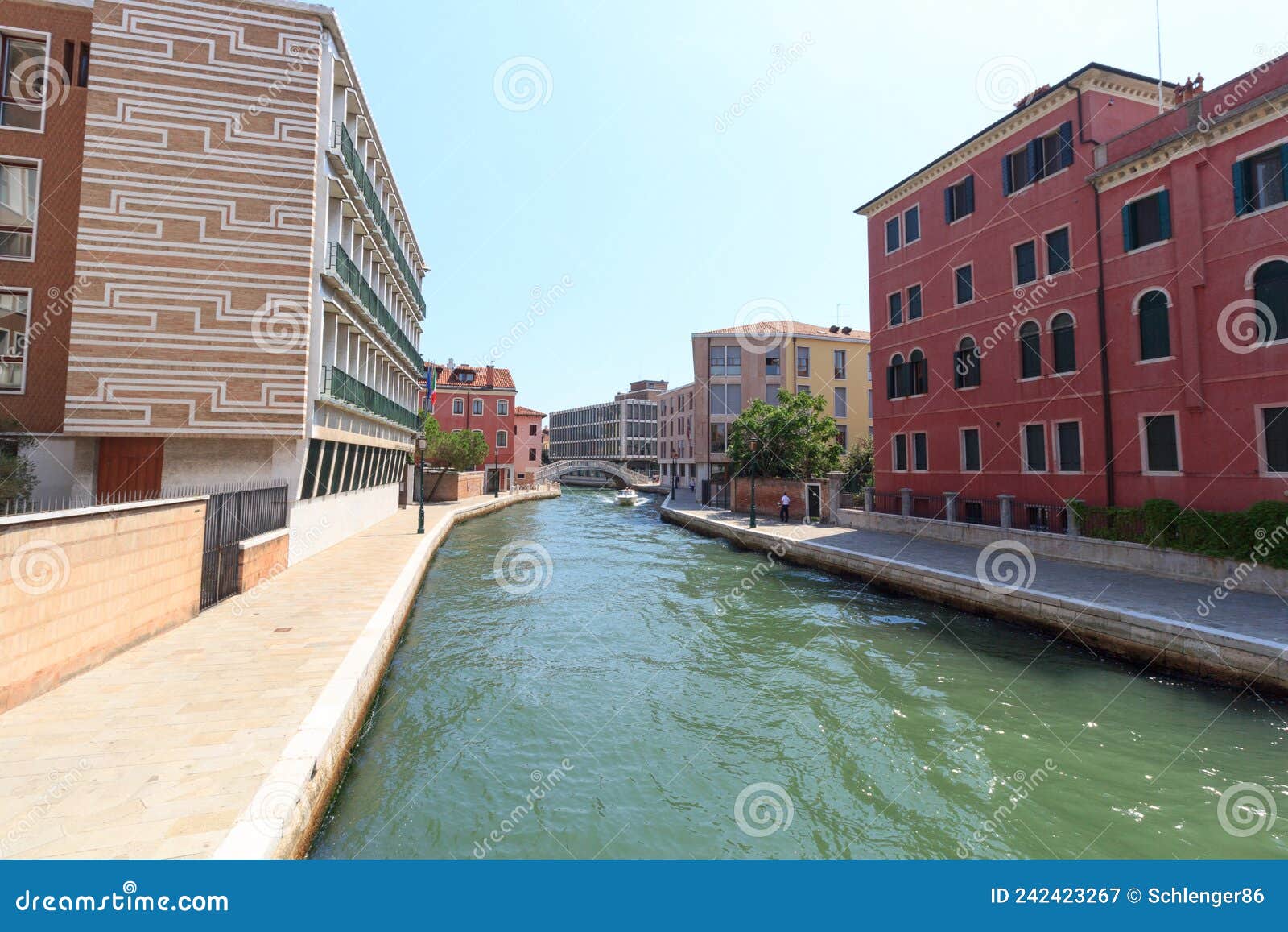 channel with boat and modern buildings in district sestiere santa croce in venice, italy