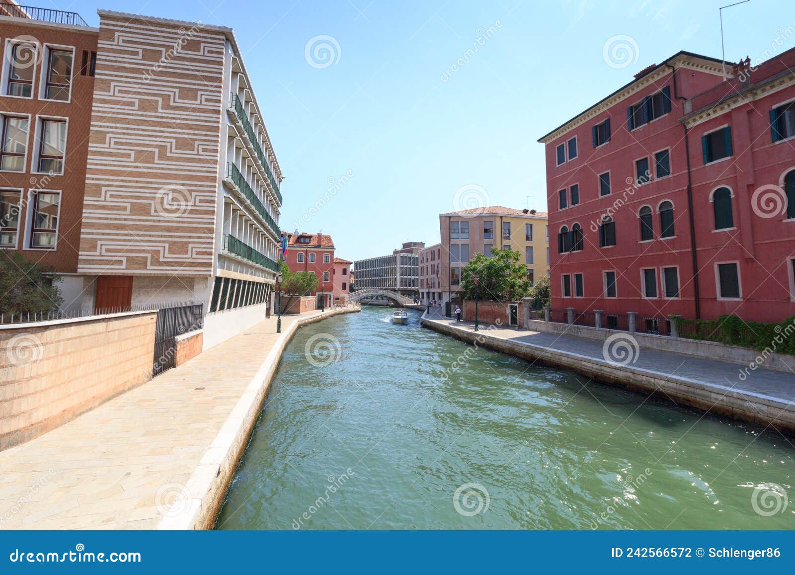 channel with boat and modern buildings in district sestiere santa croce in venice, italy