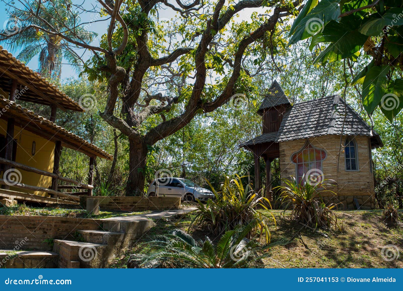 chapel of prayers, next to large trees, in a public park.