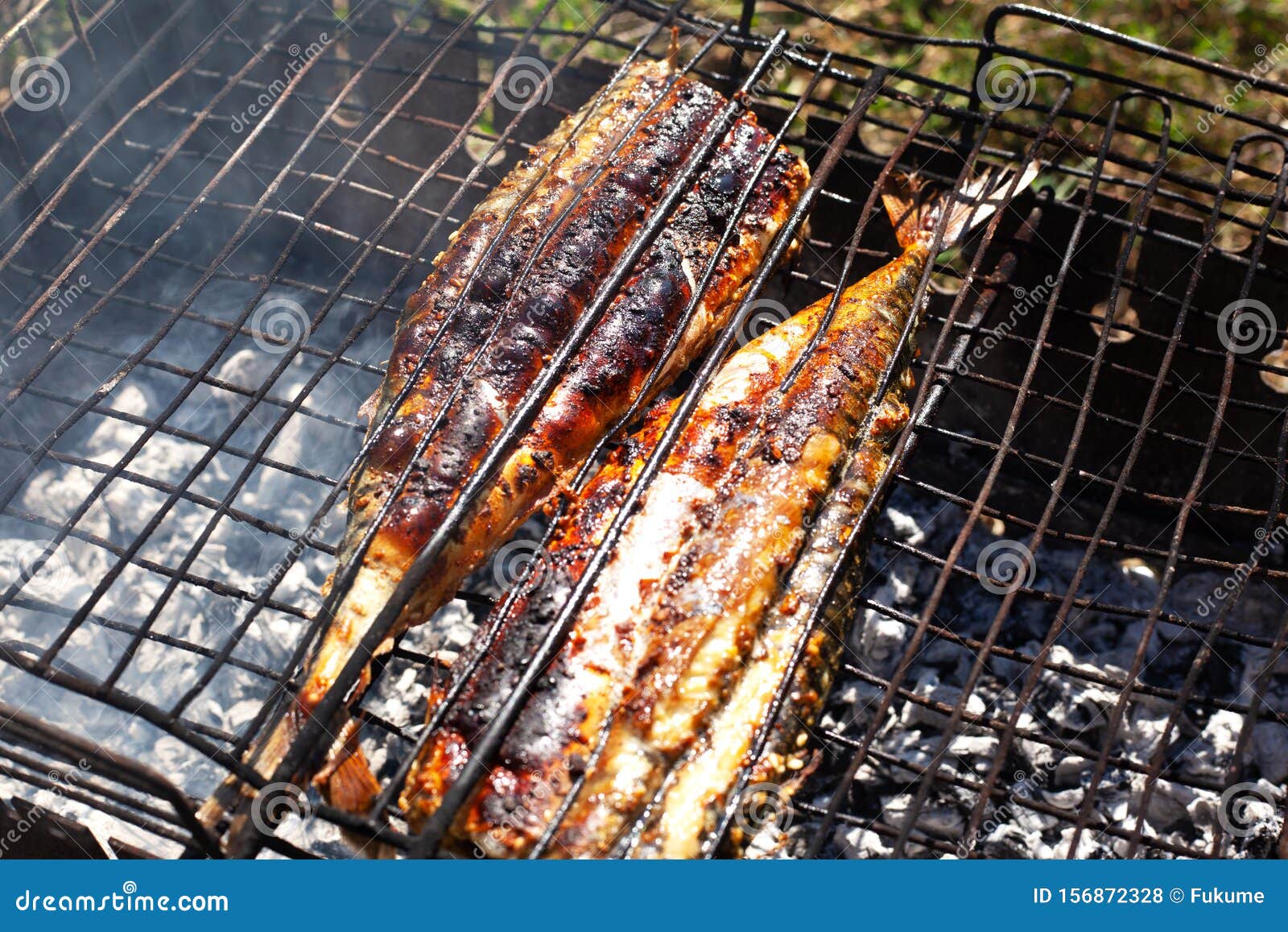 Charcoal Grilled Fish,the Process of Preparing Fried Mackerel in the Fresh Air Stock Photo