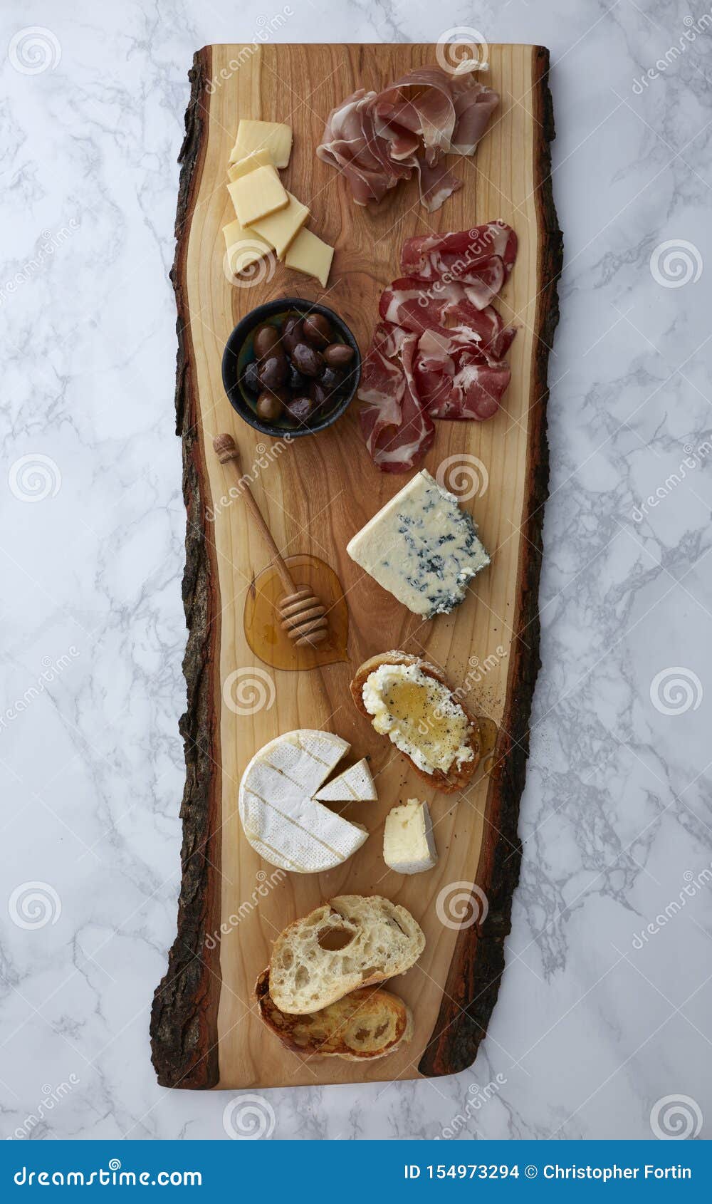 charcuterie on a rustic cutting board on a marble surface