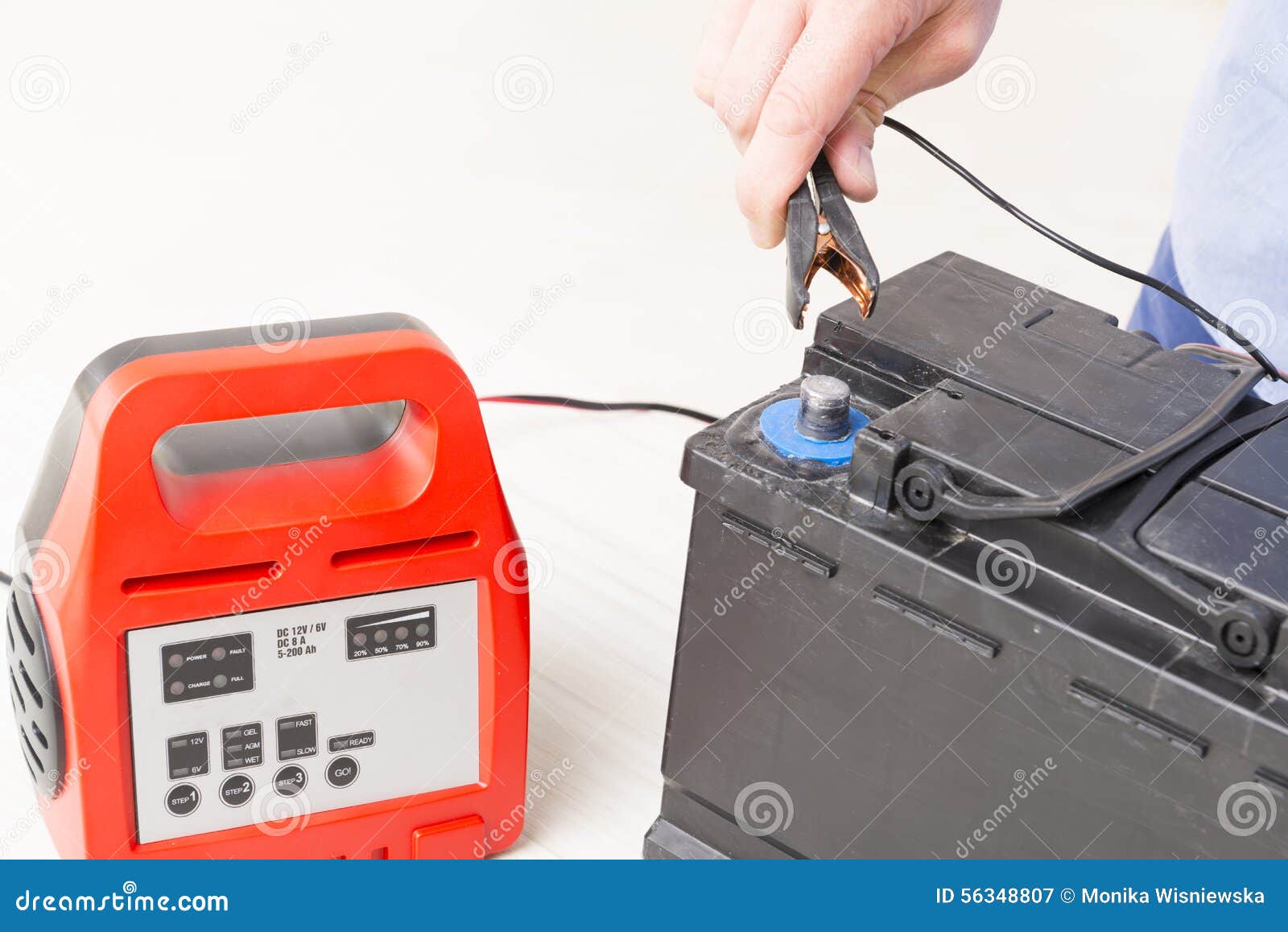 Charging car battery stock image. Image of hand, measuring 56348807
