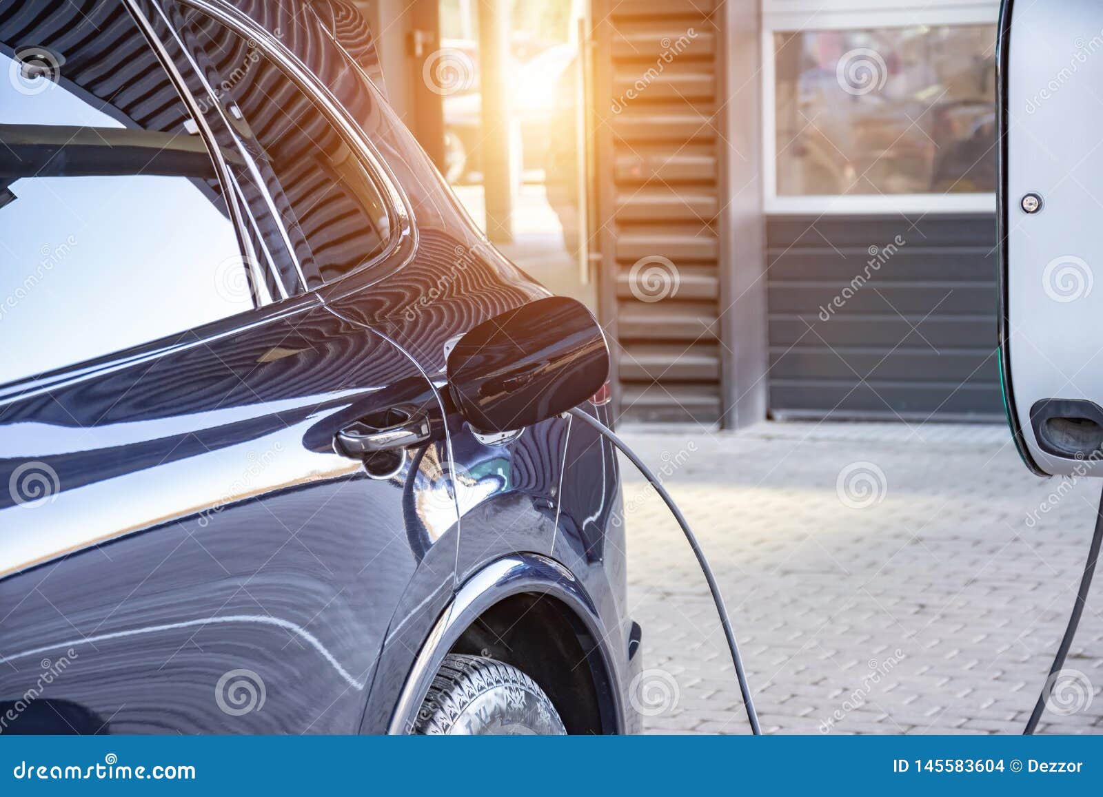 charging an electric car at a car repair shop service garage. refueling for electric cars e-mobility