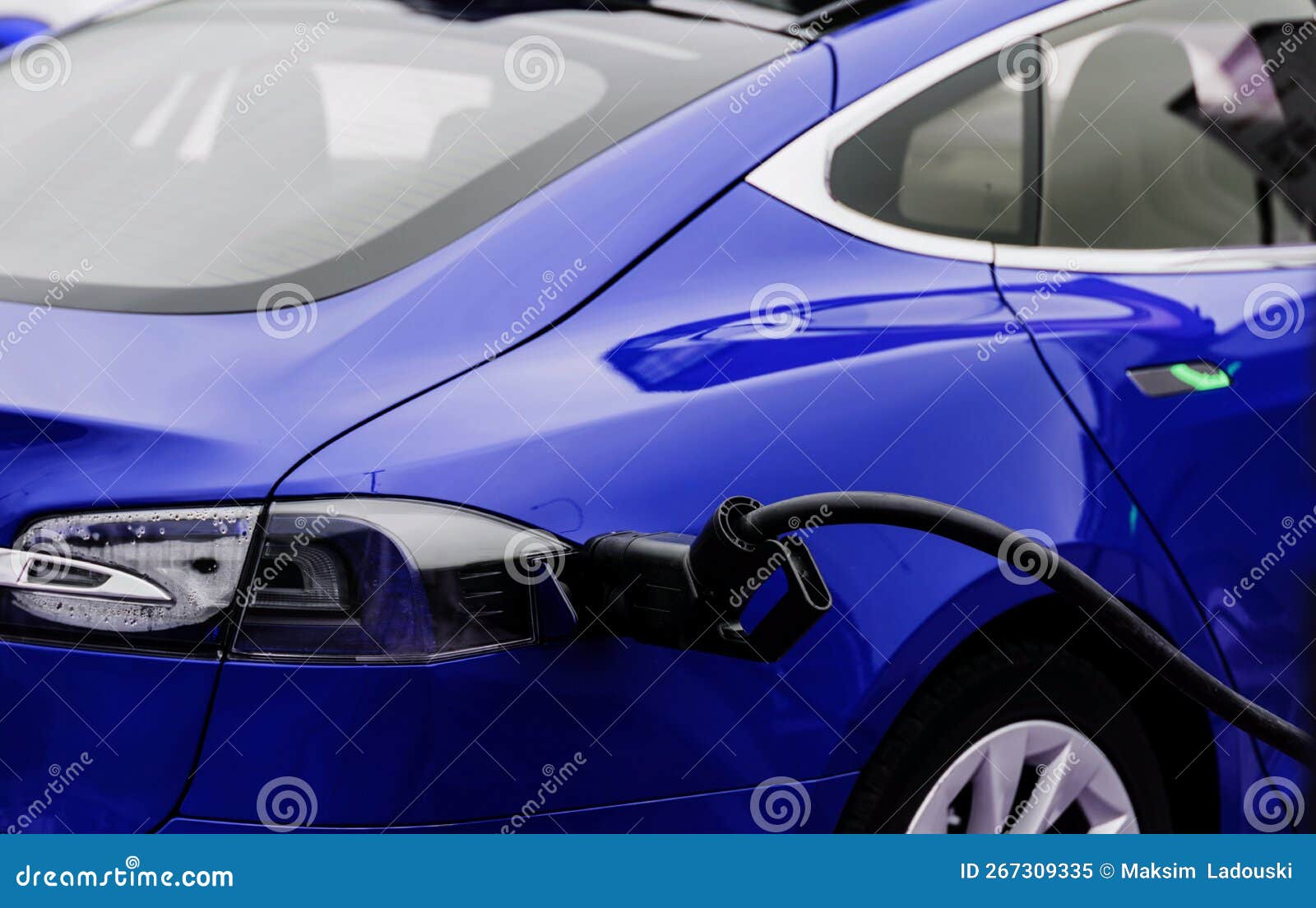 Charging an electric car stock image. Image of cable 267309335