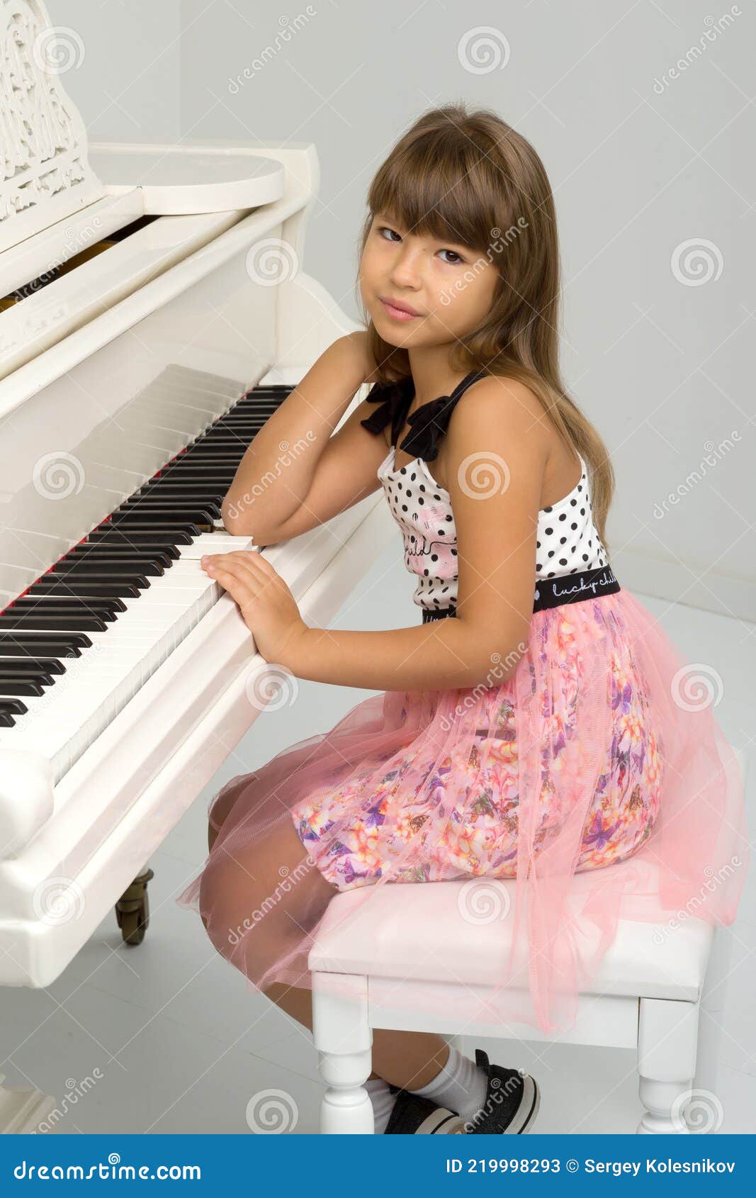 Charmante Fille Assise Au Piano à Queue Blanc Image stock - Image du  amusement, femelle: 219998293