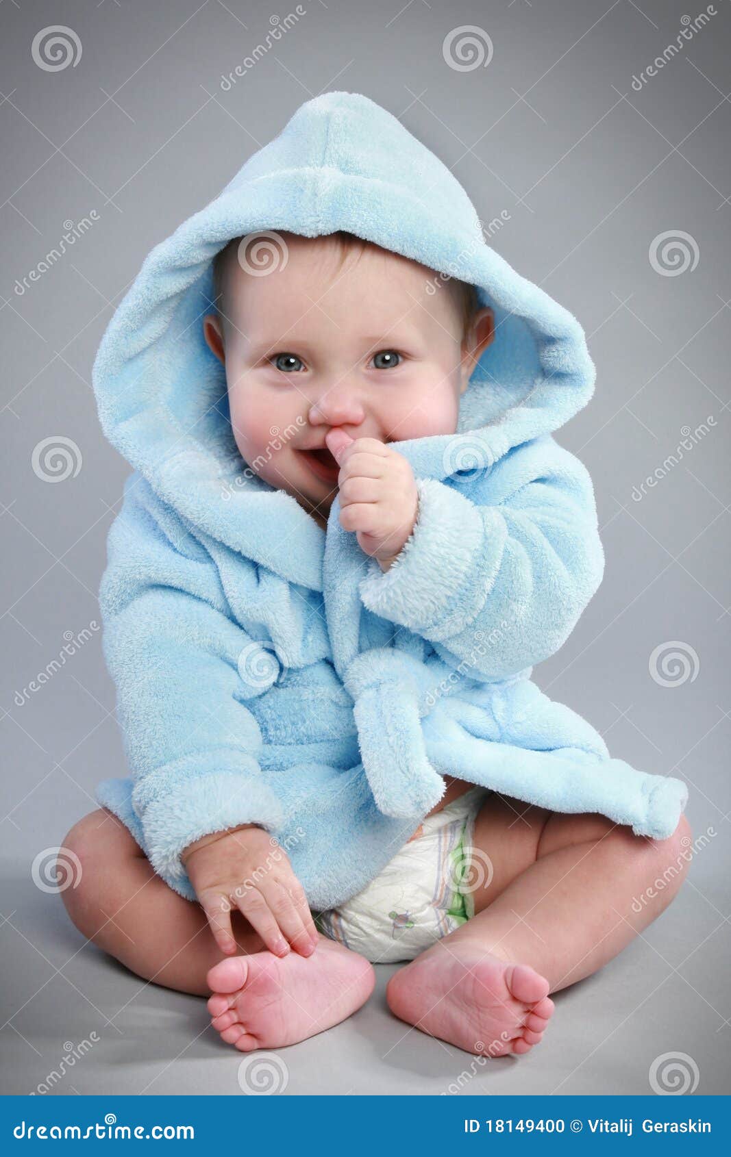 charming baby in a blue bathrobe