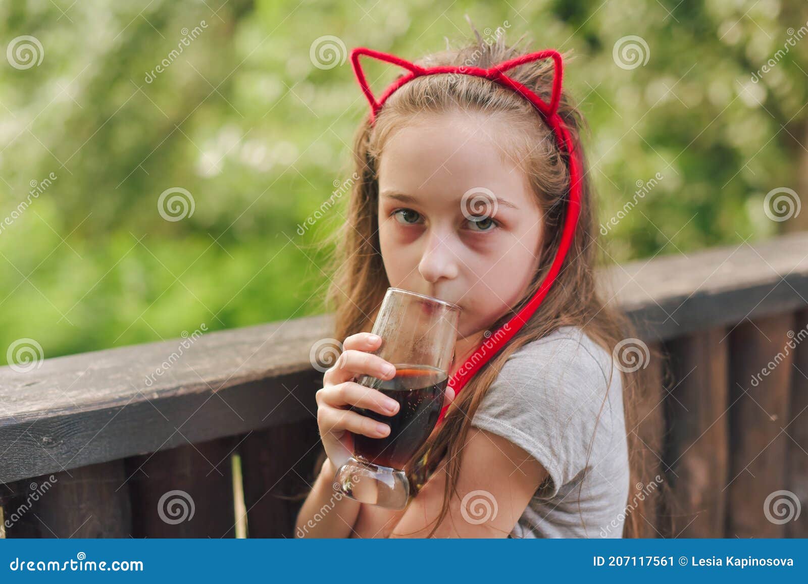 Girl Drinks from a Glass in a Summer Street Cafe. Leisure in the Cafe ...