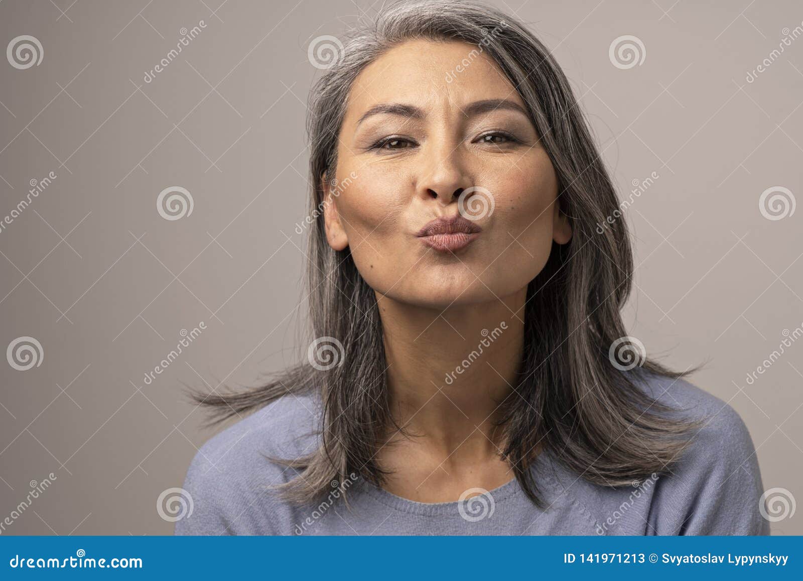 https://thumbs.dreamstime.com/z/charming-mongolian-woman-gray-hair-over-background-gently-sends-kiss-to-frame-beauty-concept-close-up-shoot-141971213.jpg