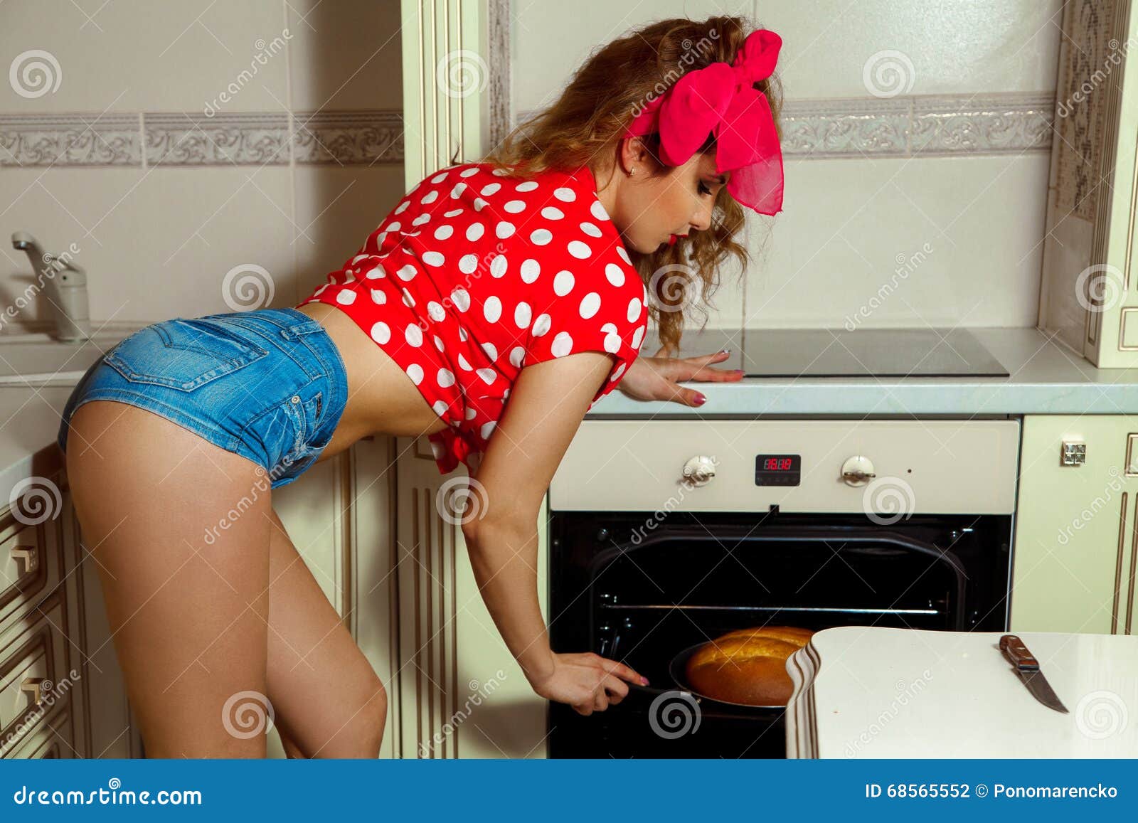 Charming Girl Bakes Bread In Clothes Pin Up Style Stock