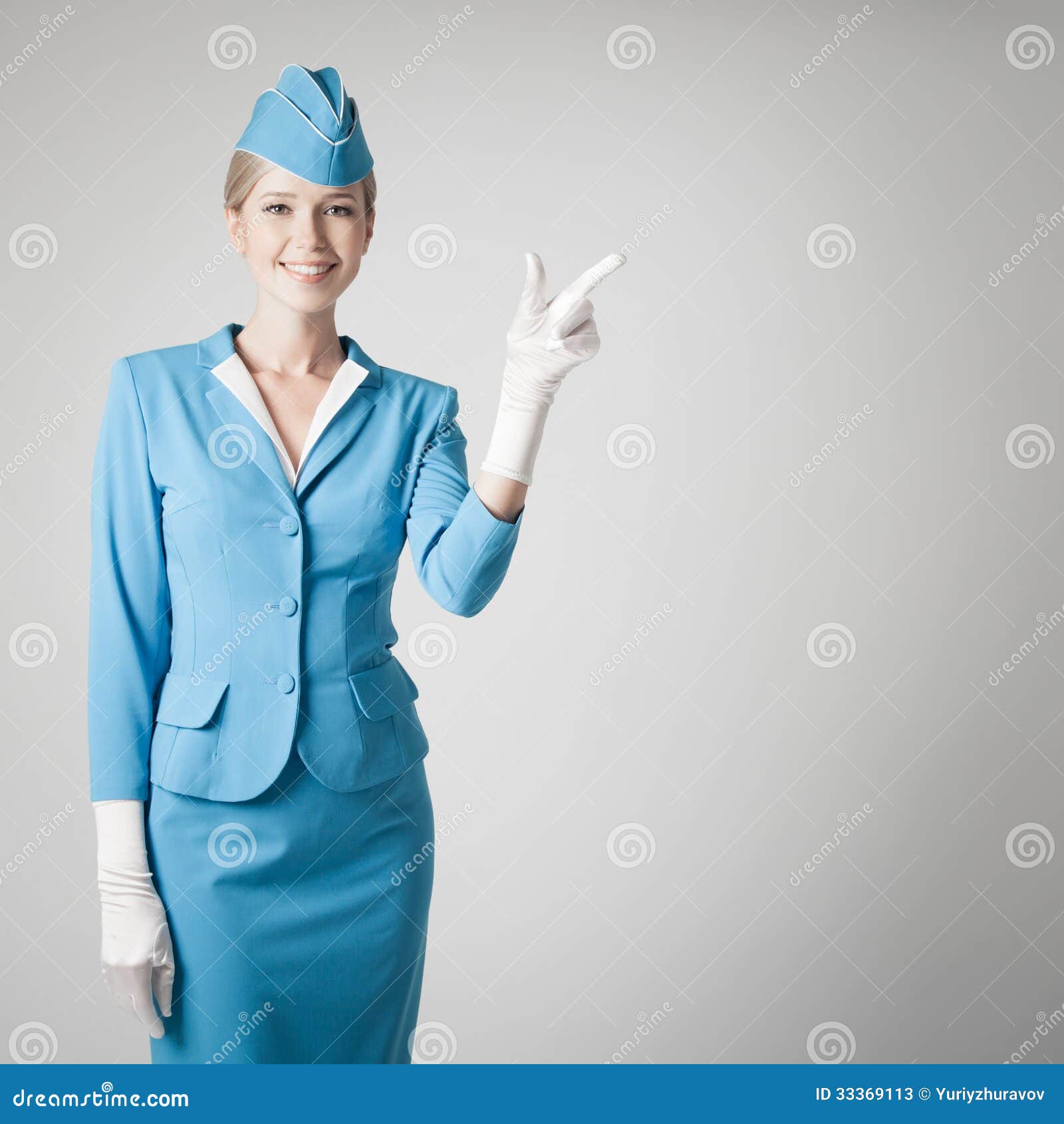 charming stewardess in blue uniform pointing the finger
