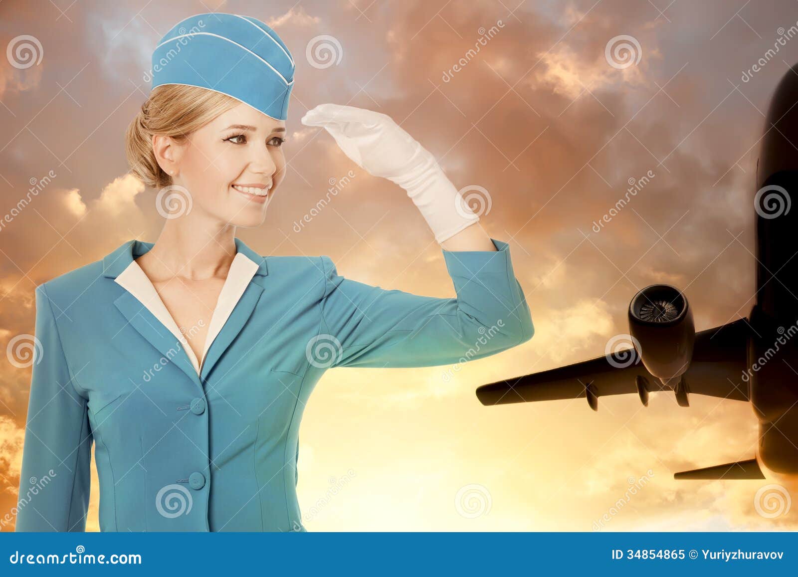 charming stewardess dressed in blue uniform on sky background