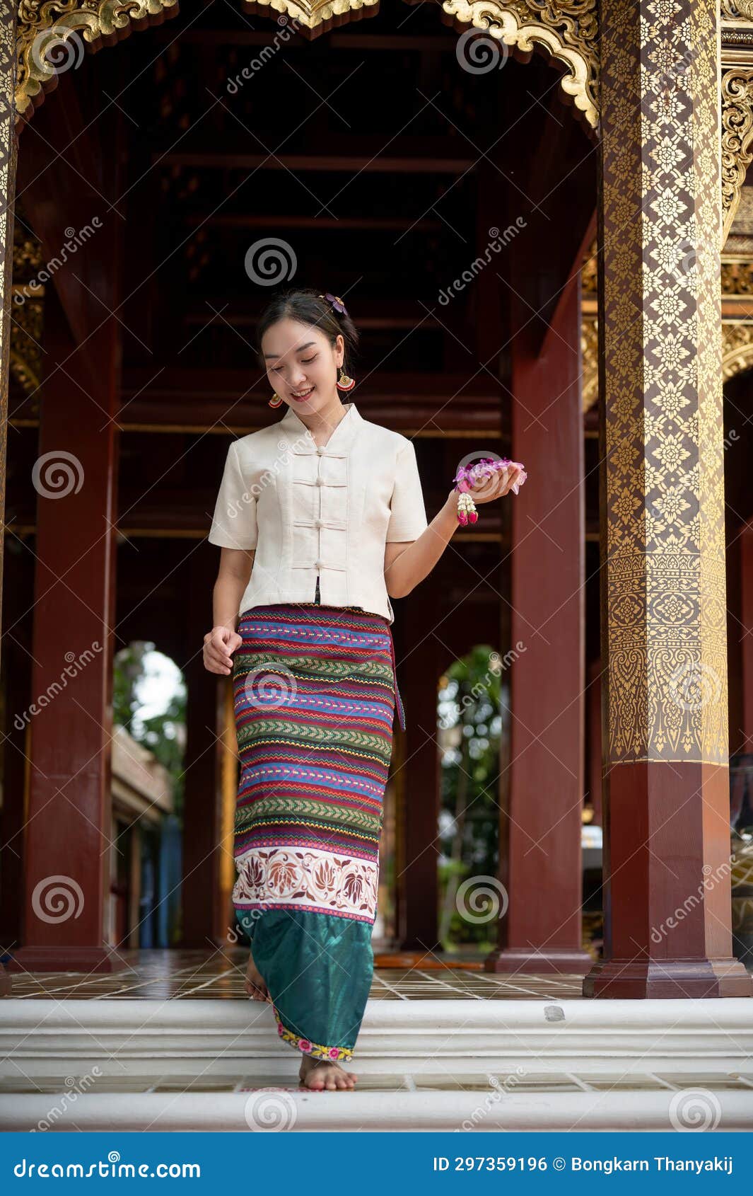A Charming Thai-Asian Woman in a Traditional Dress is Walking Down the ...