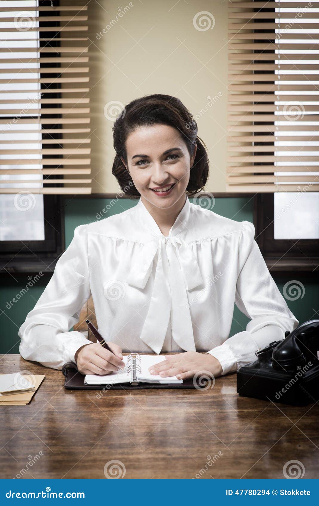 Charming Vintage Receptionist Working at Office Desk Stock Photo